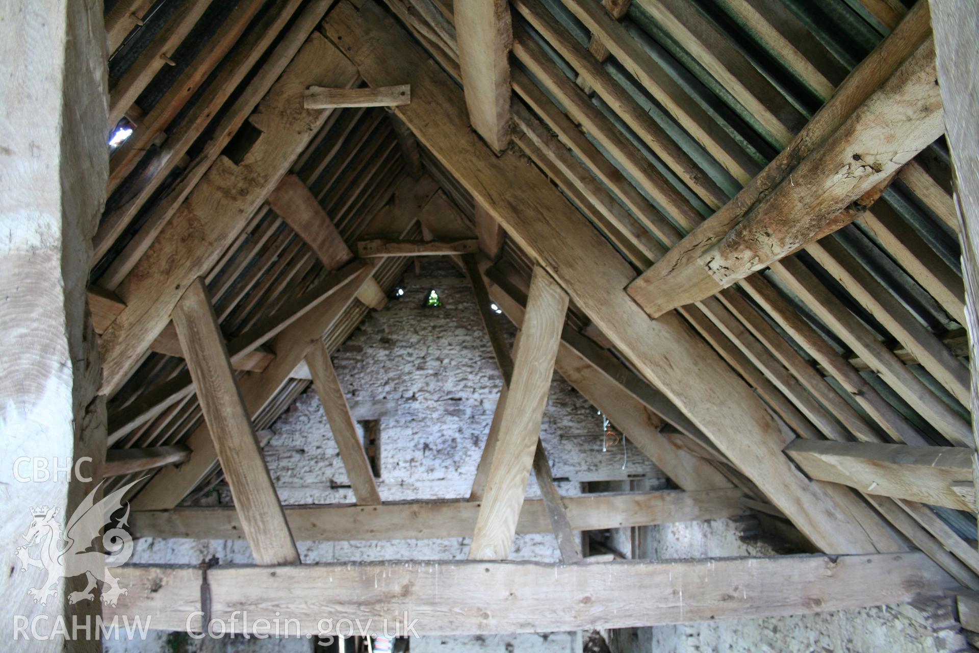 Interior of framed barn, roof-truss at threshing-bay.