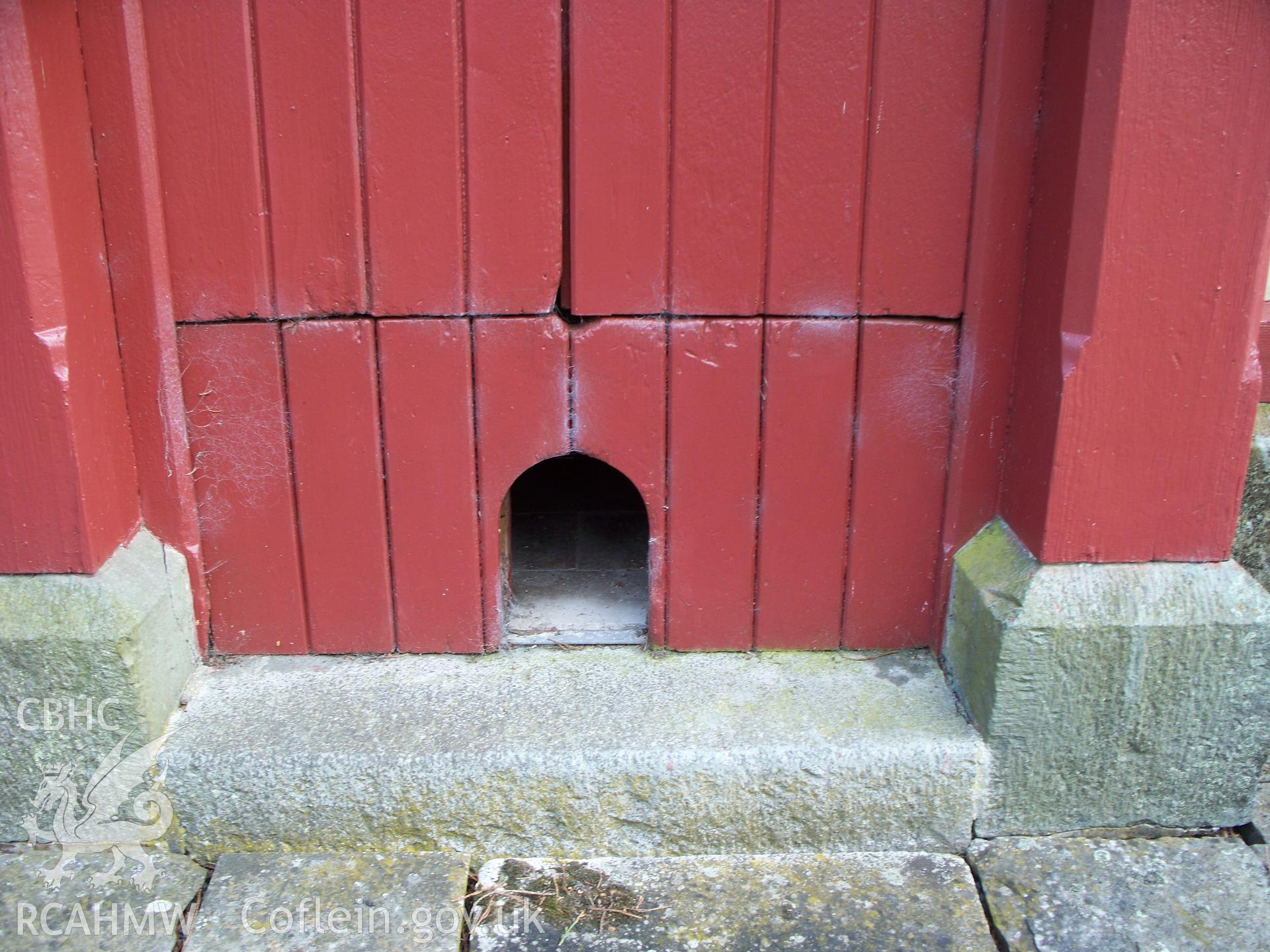 Smaller ornamental fowl door on NW front.