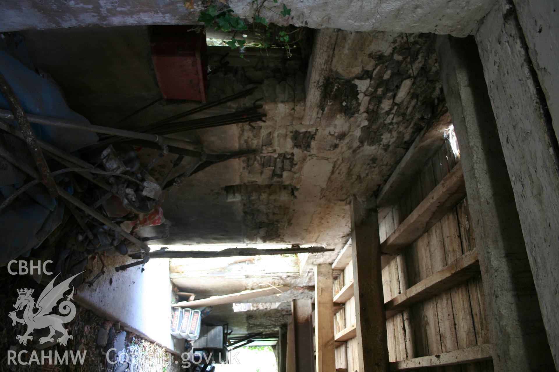 Interior of cow/house stable showing view from barn  towards doorway at east.gable-end.