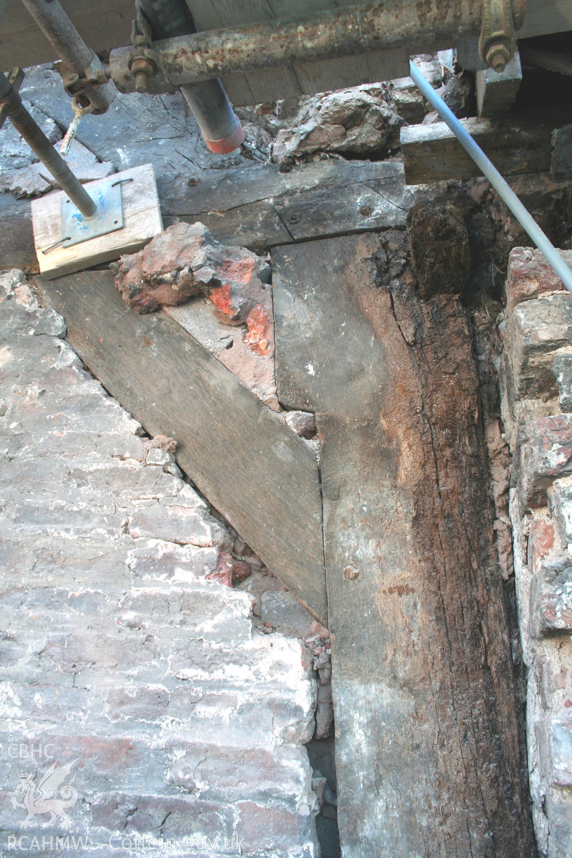 Exterior, of north gable-end showing principal-post, tie-beam & up-brace.