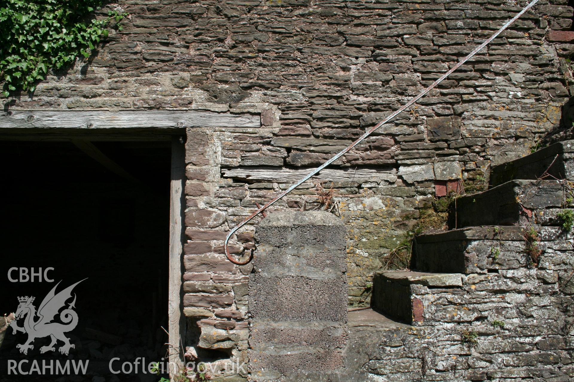 Exterior of south-west elevation of cowhouse/stable showing doorway and stair to granary over.