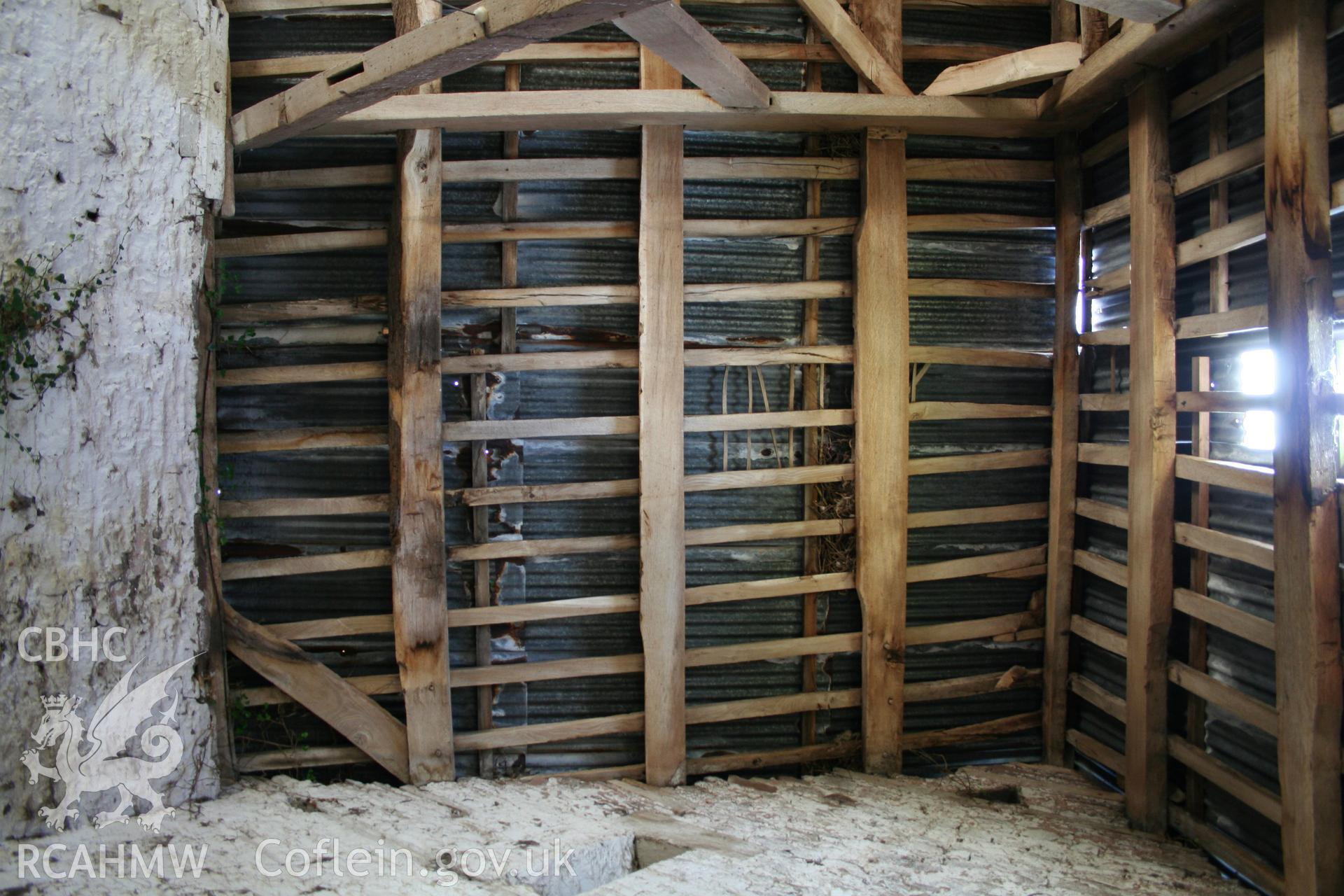 Interior of framed barn, showing purlins rafters & wind-brace at west end bay.