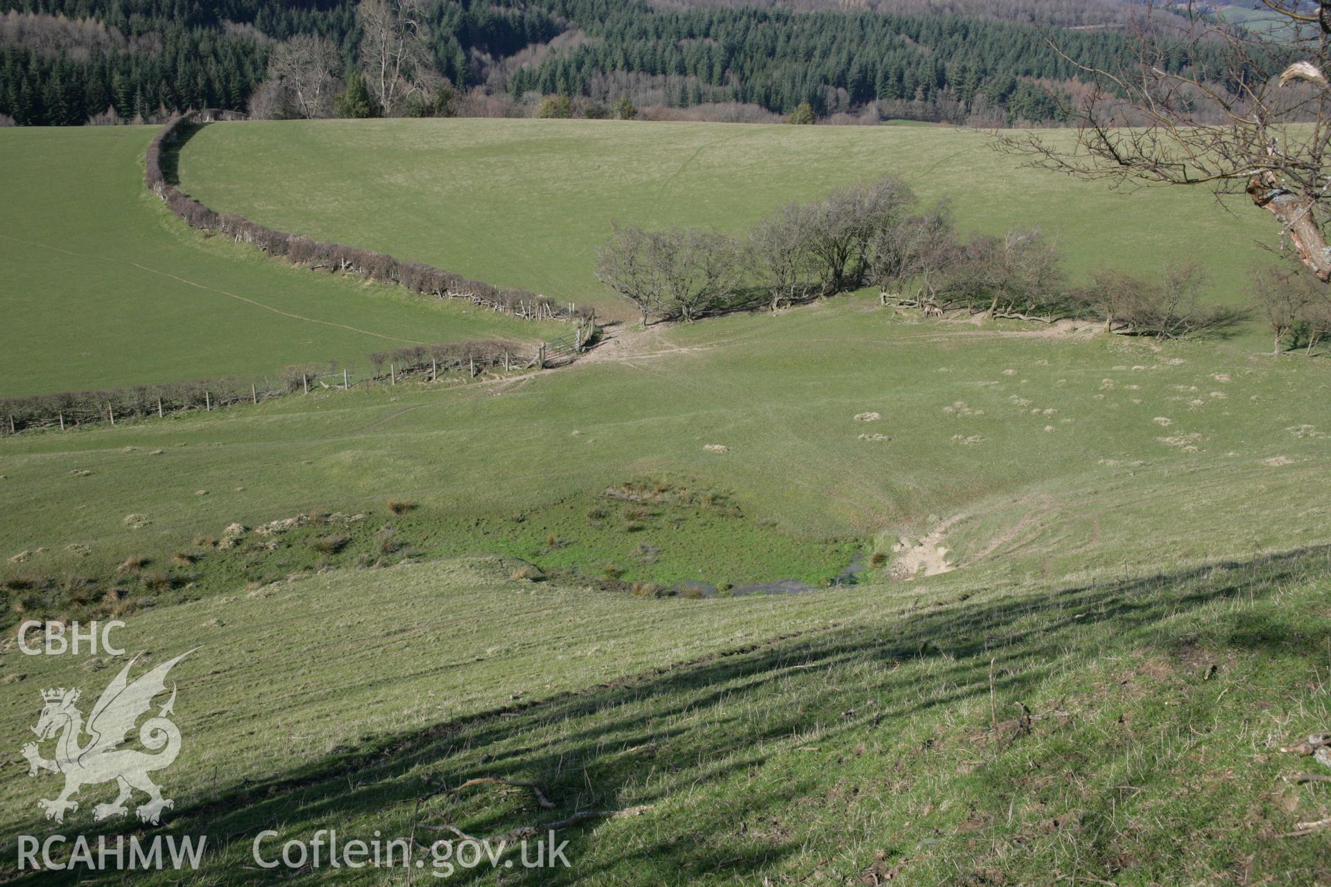 Pentre Camp: view of spring to north of hillfort, seen from hillfort defences above and to the south.