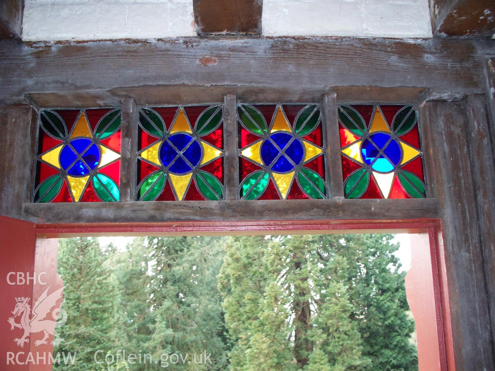 Stained-glass lights above the NW central door.