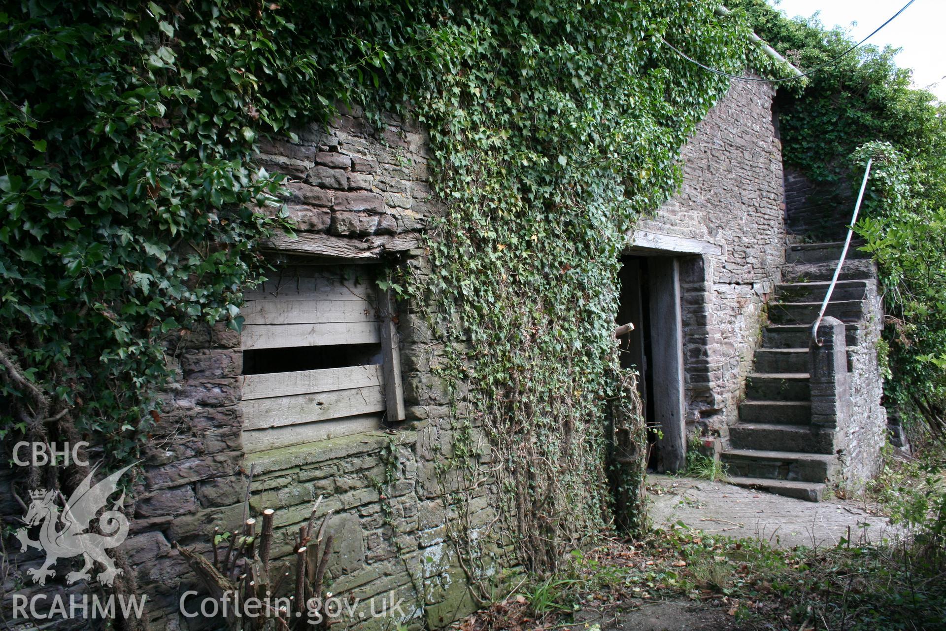 Exterior of south-west elevation of cowhouse/stable with stair to granary over.