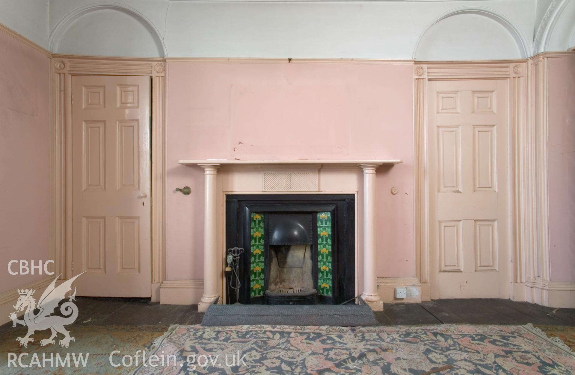 Ground floor front room, north wall with fireplace.