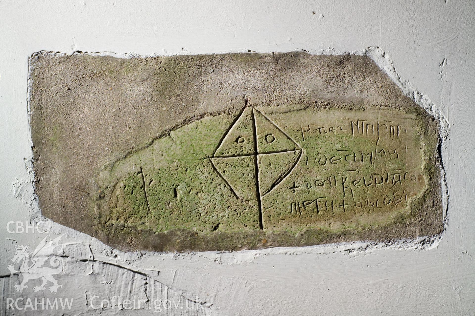 Inscribed stone set in interior north wall