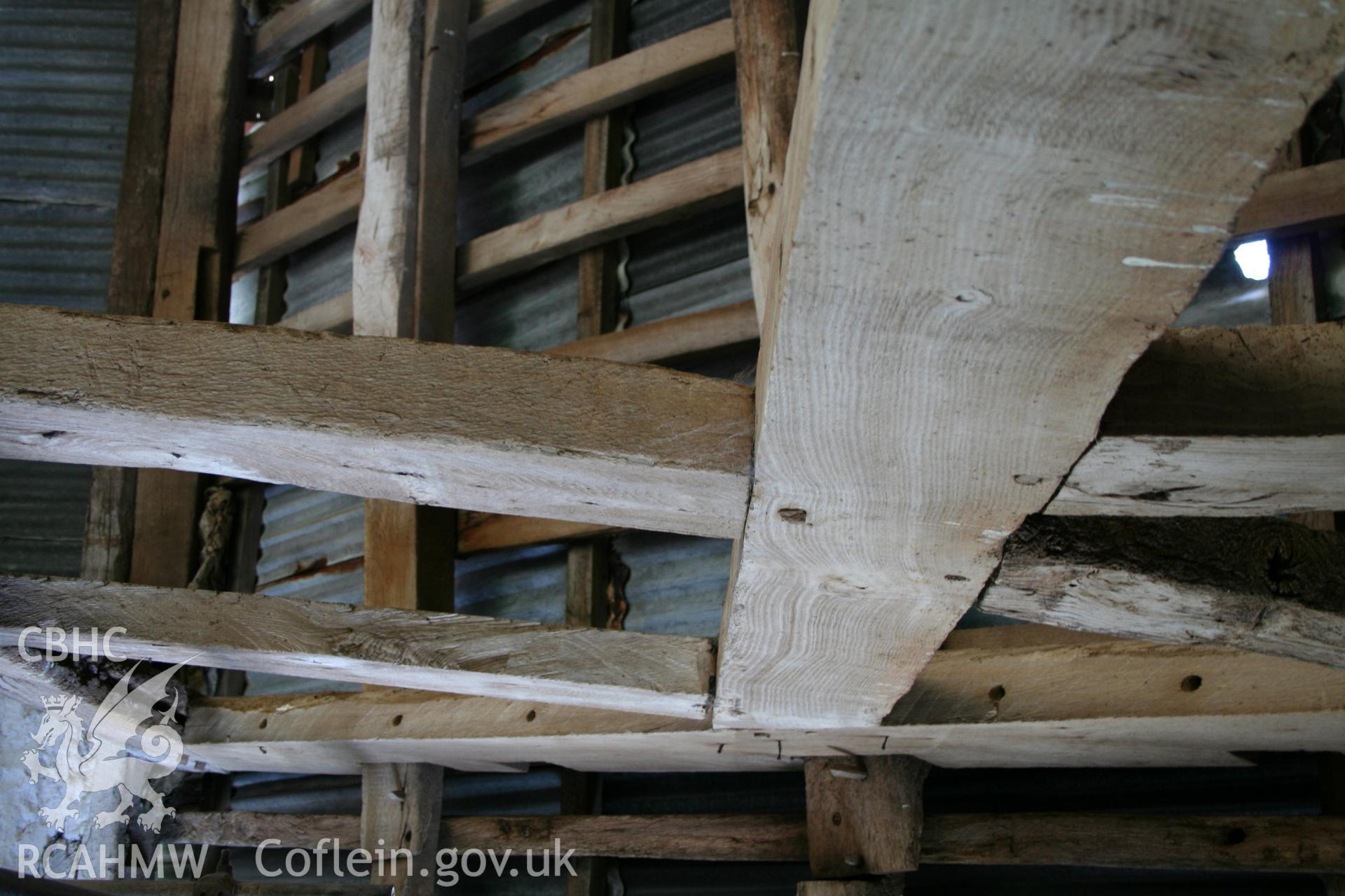 Interior of framed barn, detail at collar of end-truss.