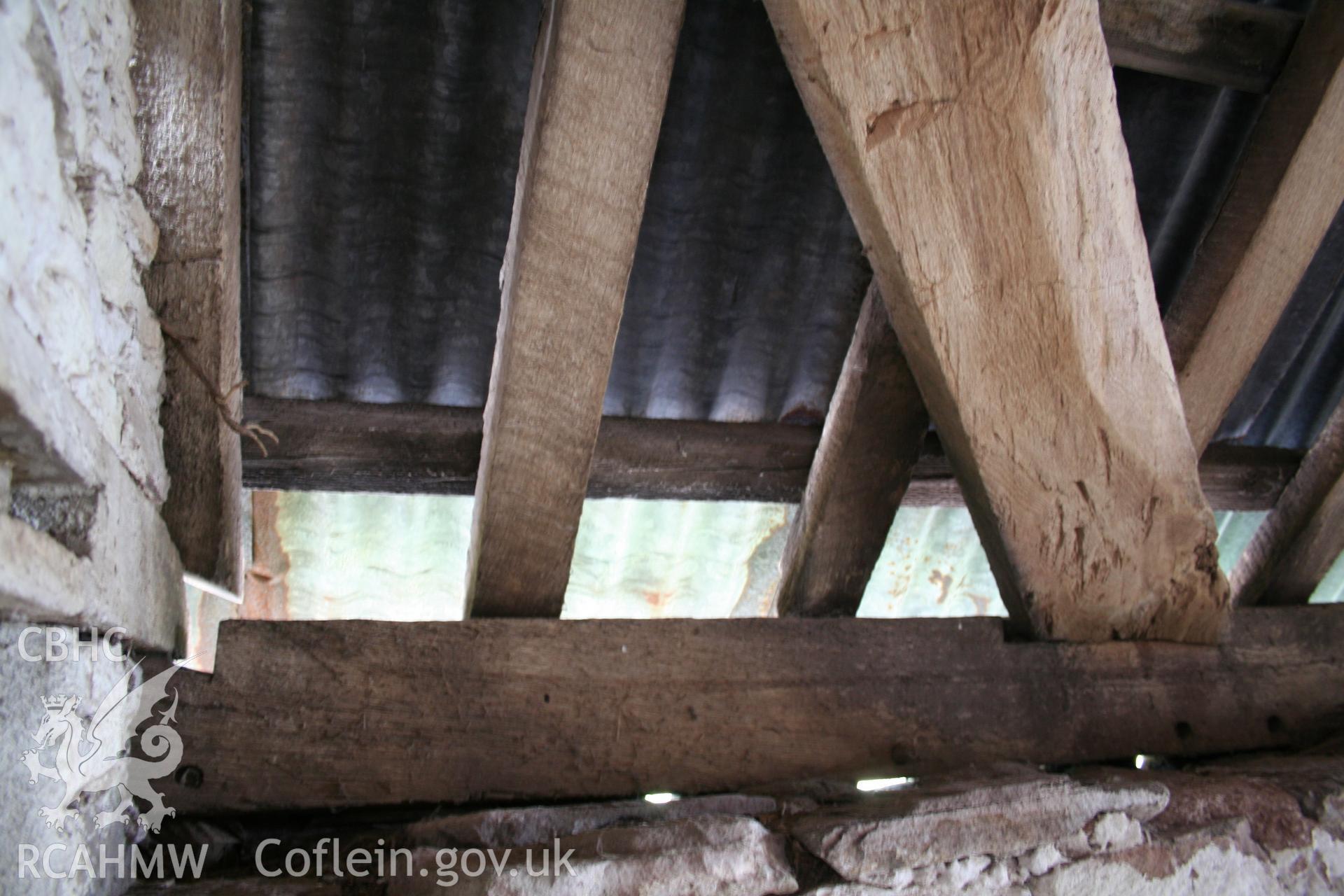 Interior of framed barn, showing wind-brace at west end bay.