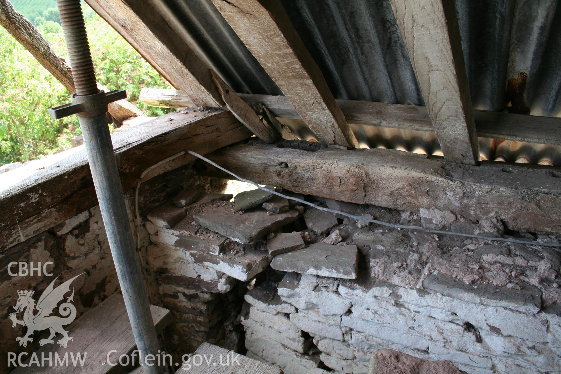 Interior truss and wall-plate to stone walled barn at east gable-end.