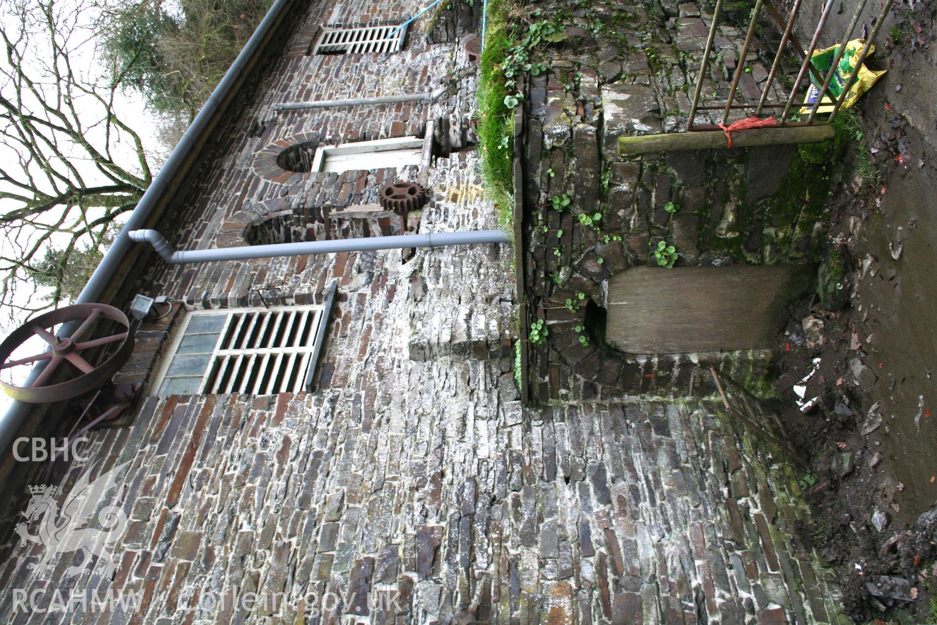 Site of water wheel against north elevation of barn range.