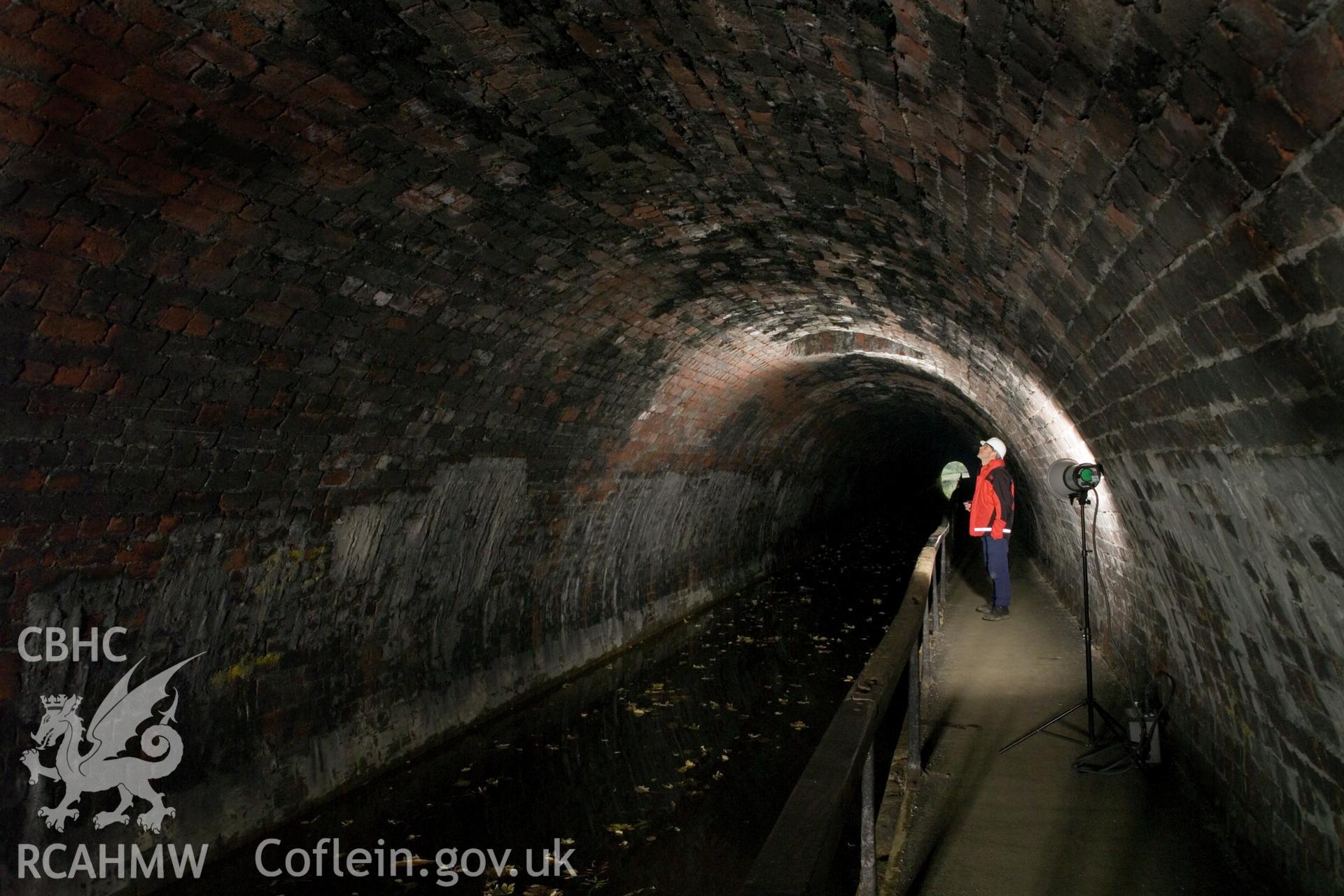 Interior, figure inspecting tunnel air vent.