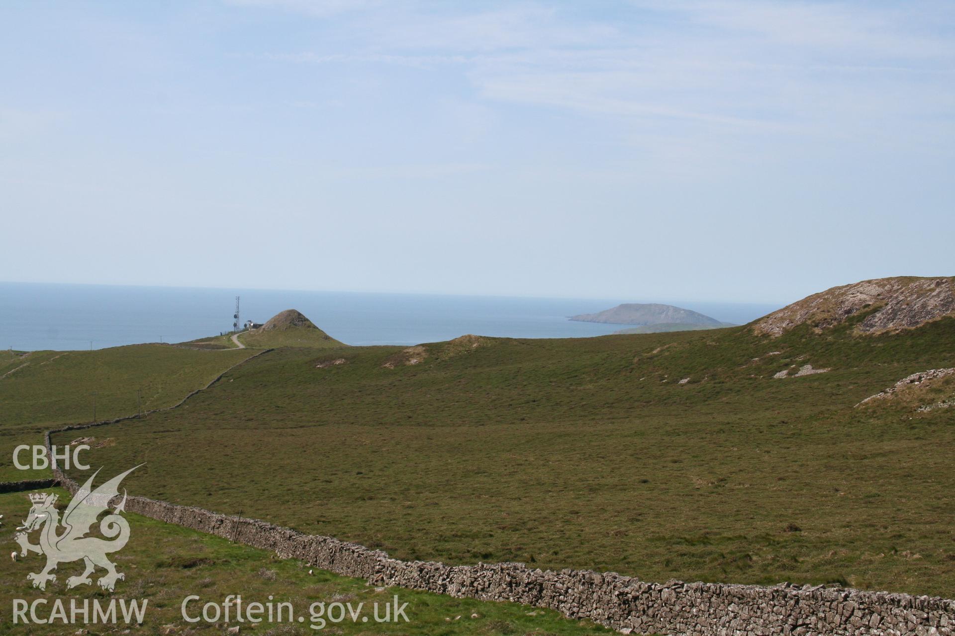 View looking south-west to the edge of the mountain, marked by a radio mast