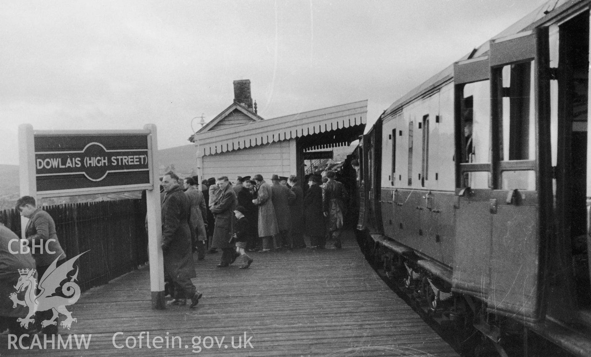 Black and white photograph showing commuters at Dowlais High Street Station, taken by H.C. Casserley, 1958. From Rokeby Collection Album VI, part 2, no 86d.