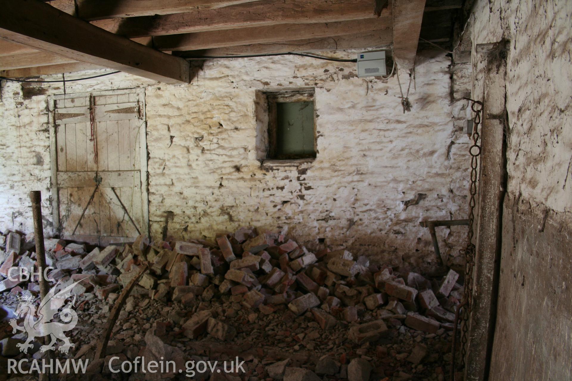 Interior of cow/house stable showing stable doorway to north-east.