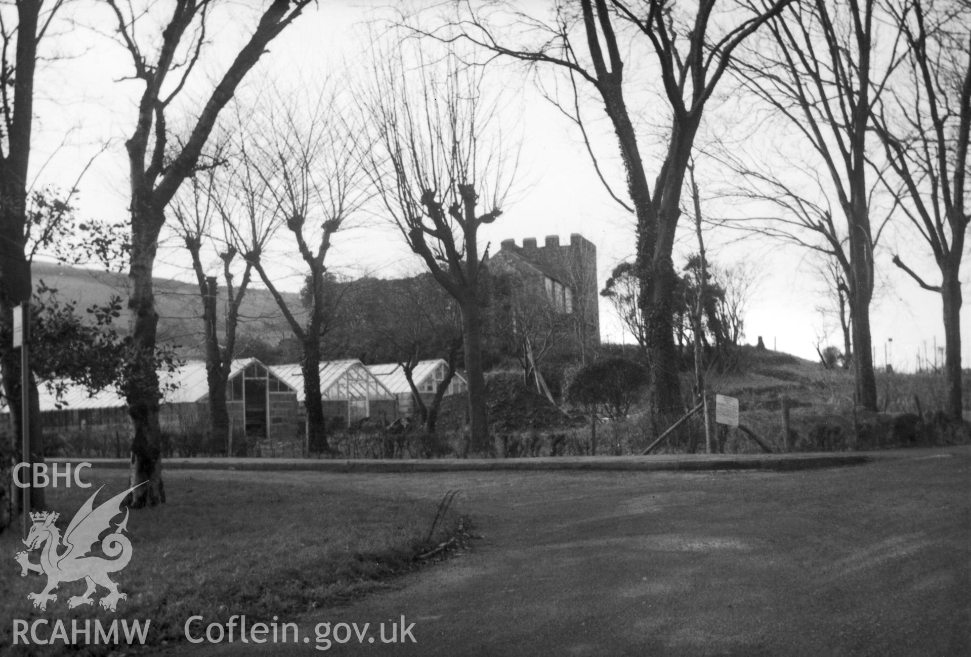 General view of Plas Crug Tower and garden including greenhouses.