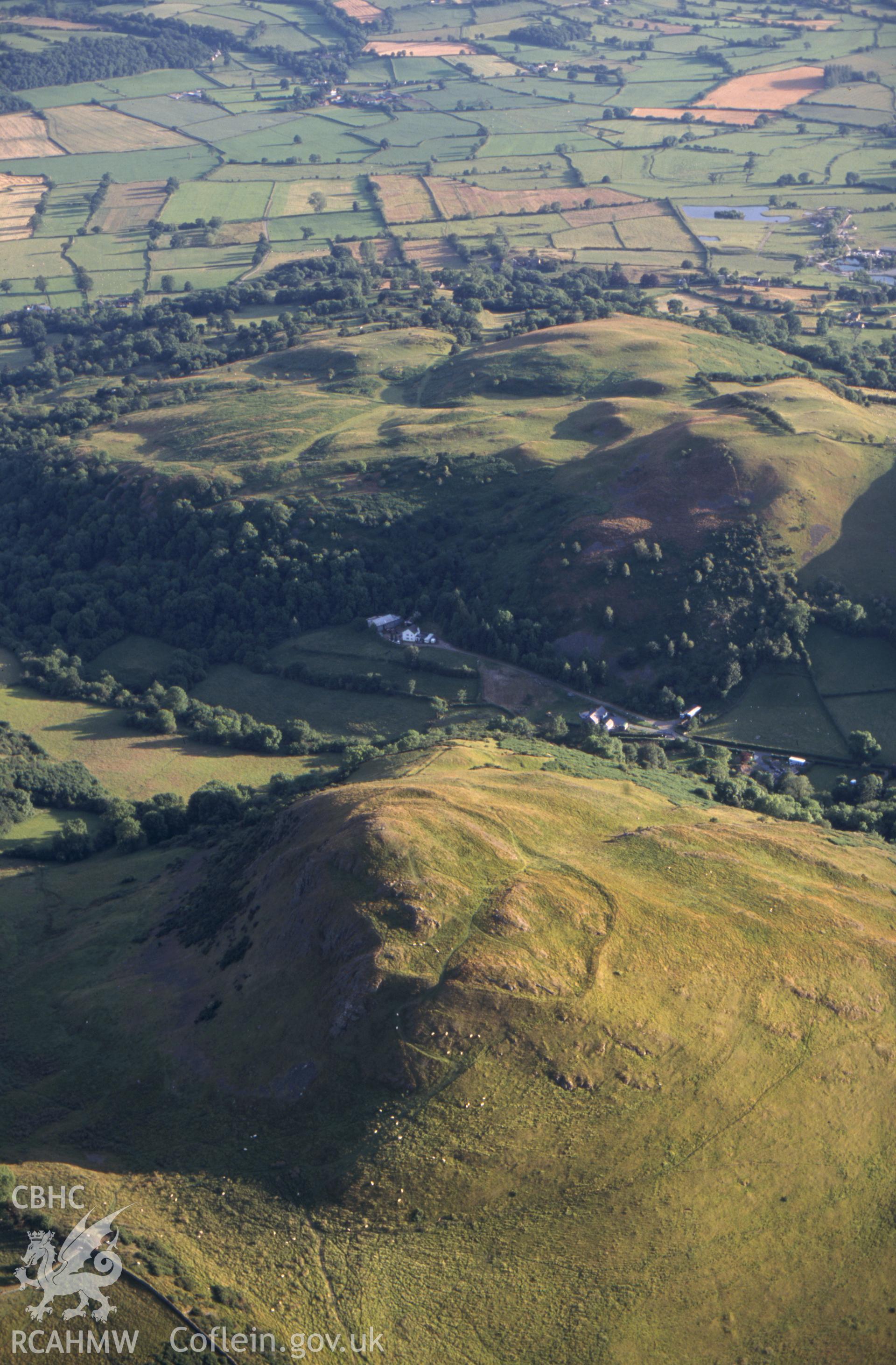 Slide of RCAHMW colour oblique aerial photograph of Roundton Hillfort, taken by T.G. Driver, 2002.