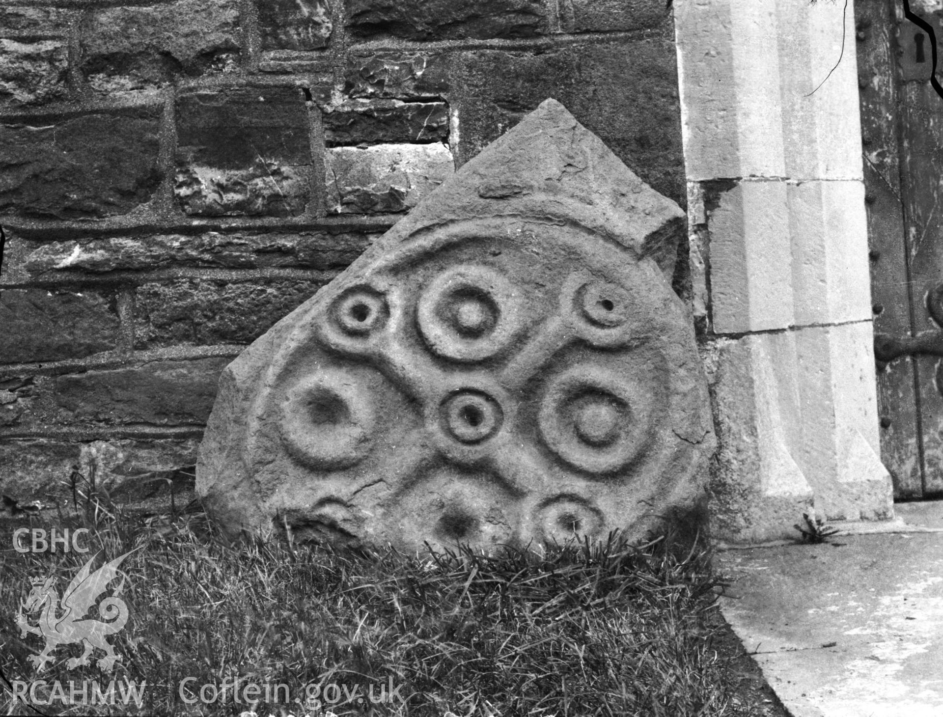 Black and white photo showing the damaged stone at Llandeilo'r Fan Church.