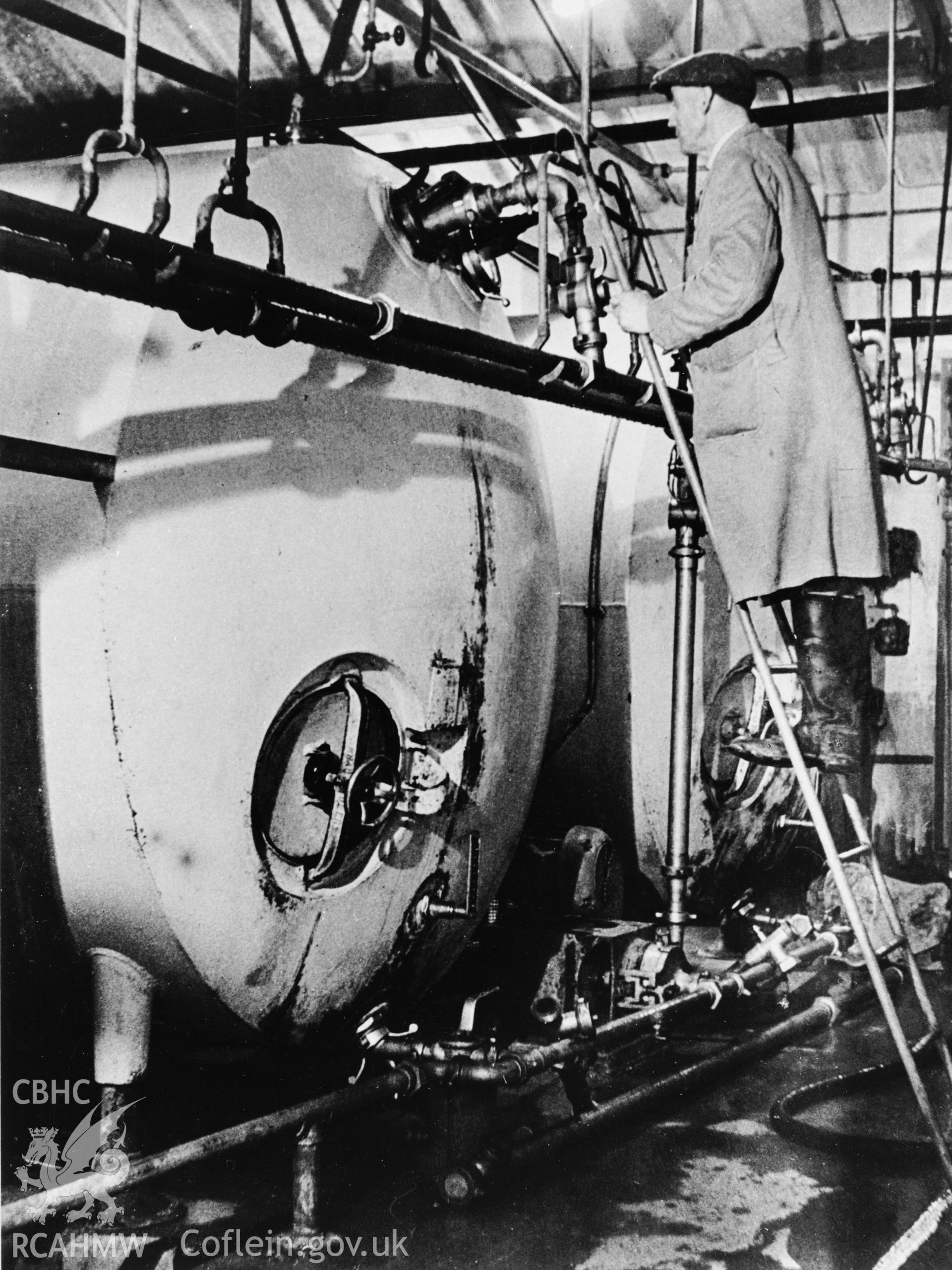 Copy of a pre-1950 photo showing milk storage tanks
