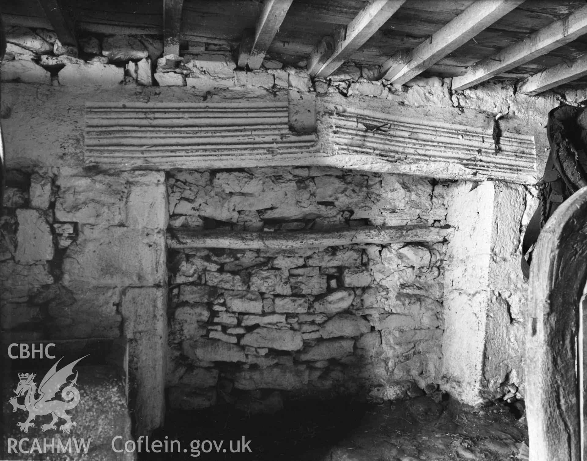 A large rectangular moulded fireplace, located in the original house (stables).