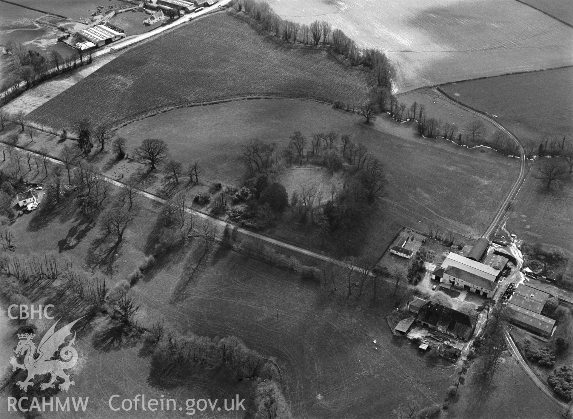 RCAHMW Black and white oblique aerial photograph of Tregrug Castle Earthwork Castle, Llangybi, taken by C.R. Musson, 24/03/94