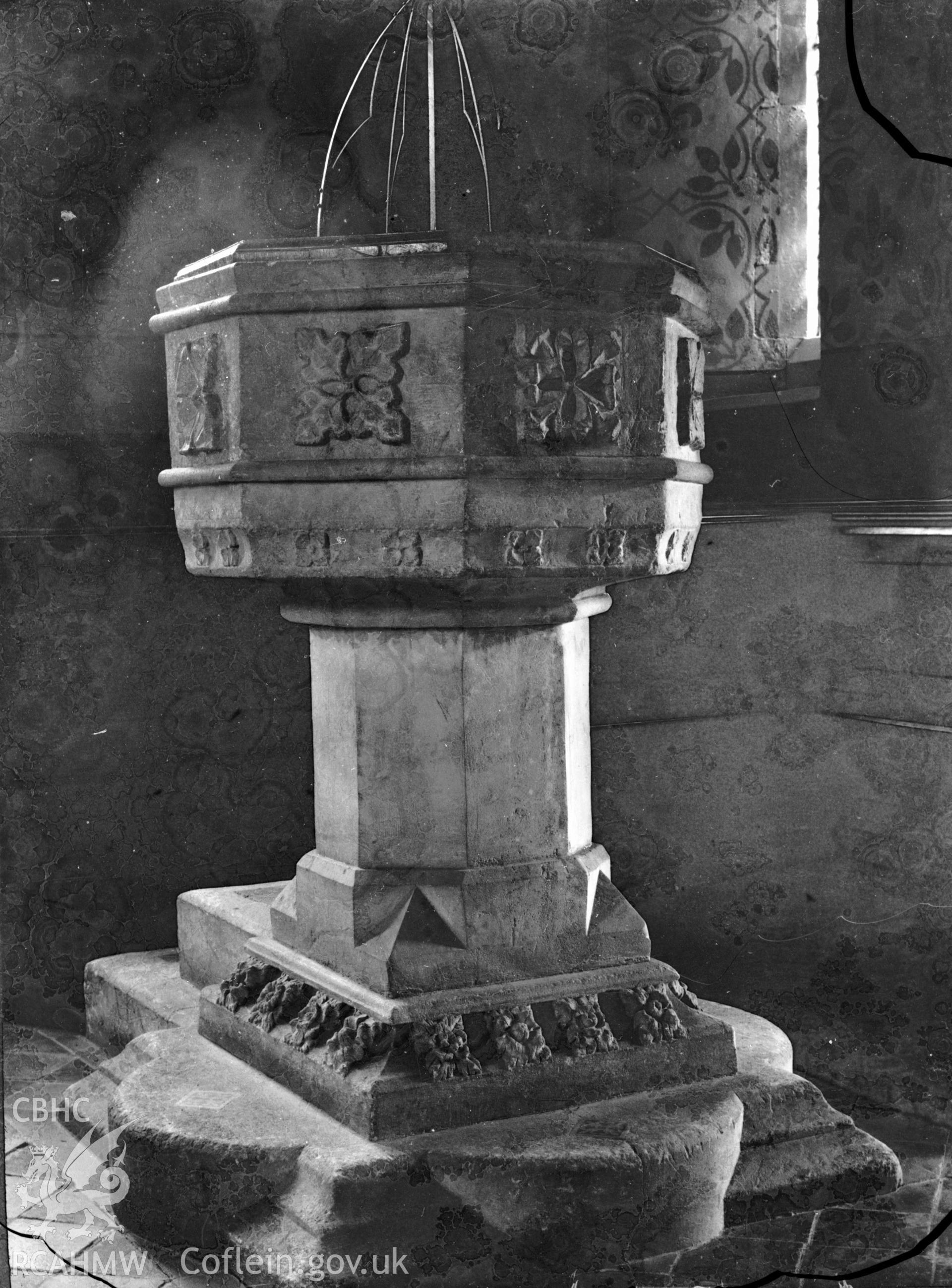 Black and white photo showing the font at Llandygwydd Church.