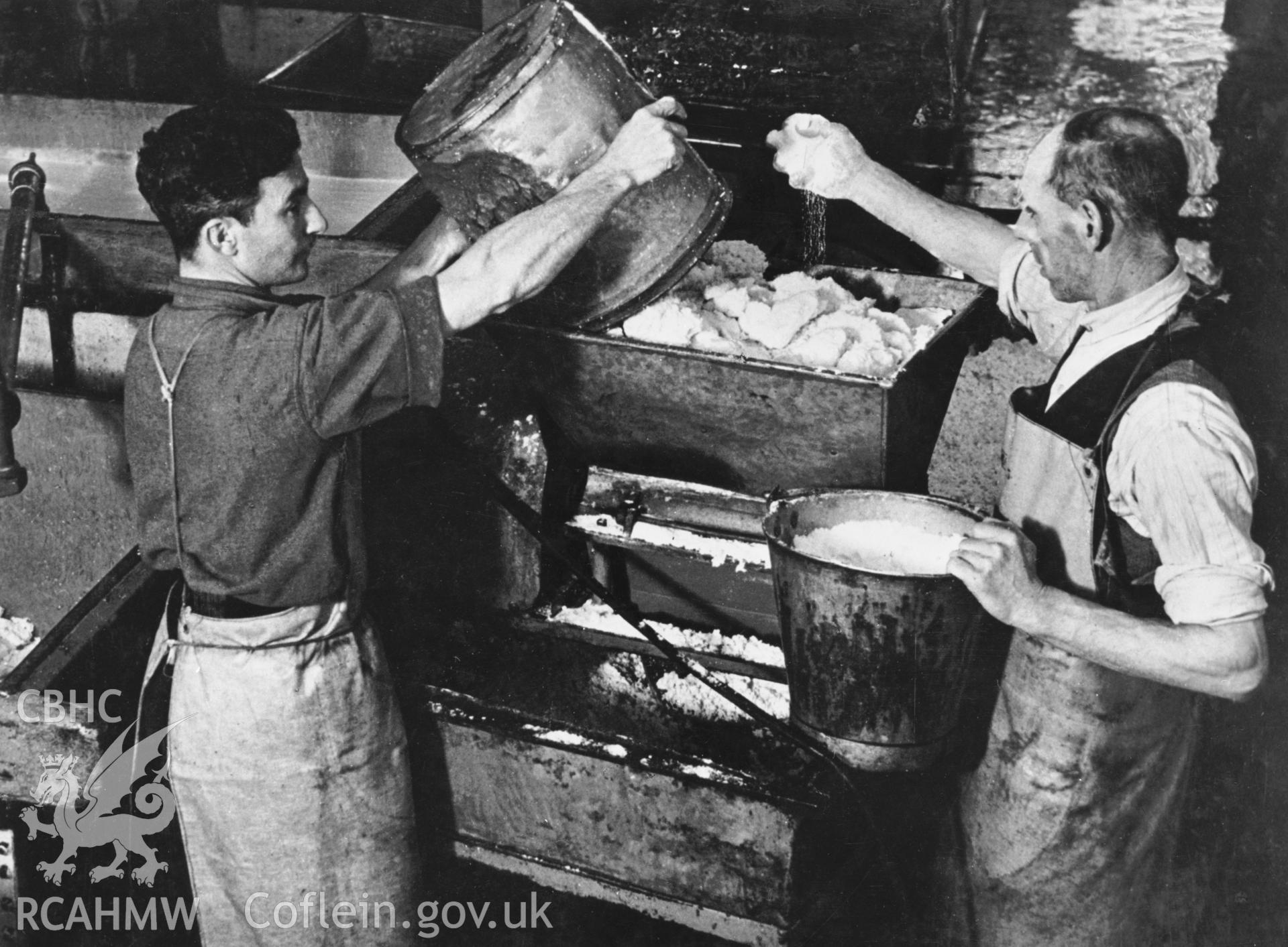 Copy of a pre-1950 photo showing stages of cheese production
