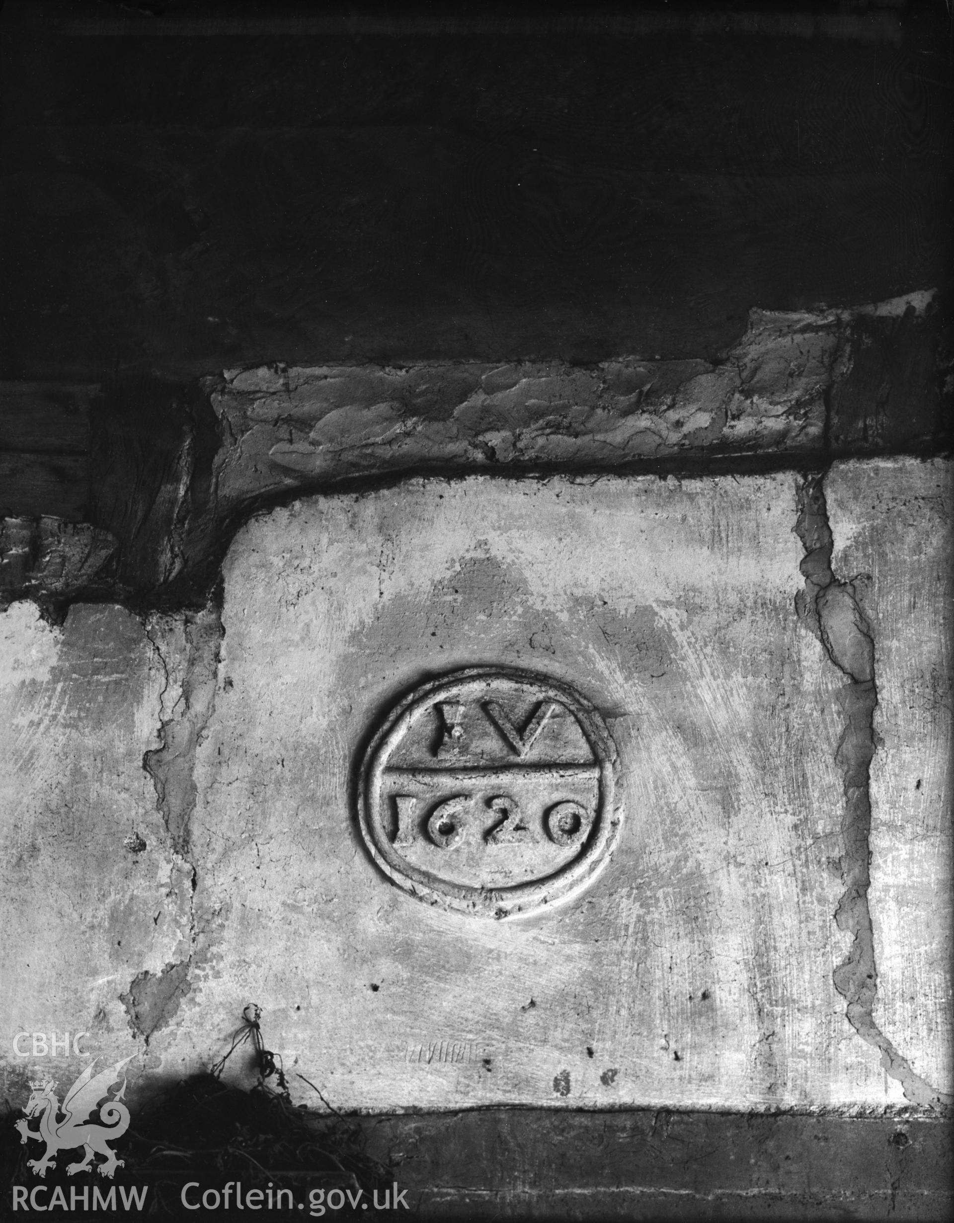 A photograph of a plaster date panel. It reads "IV 1620".