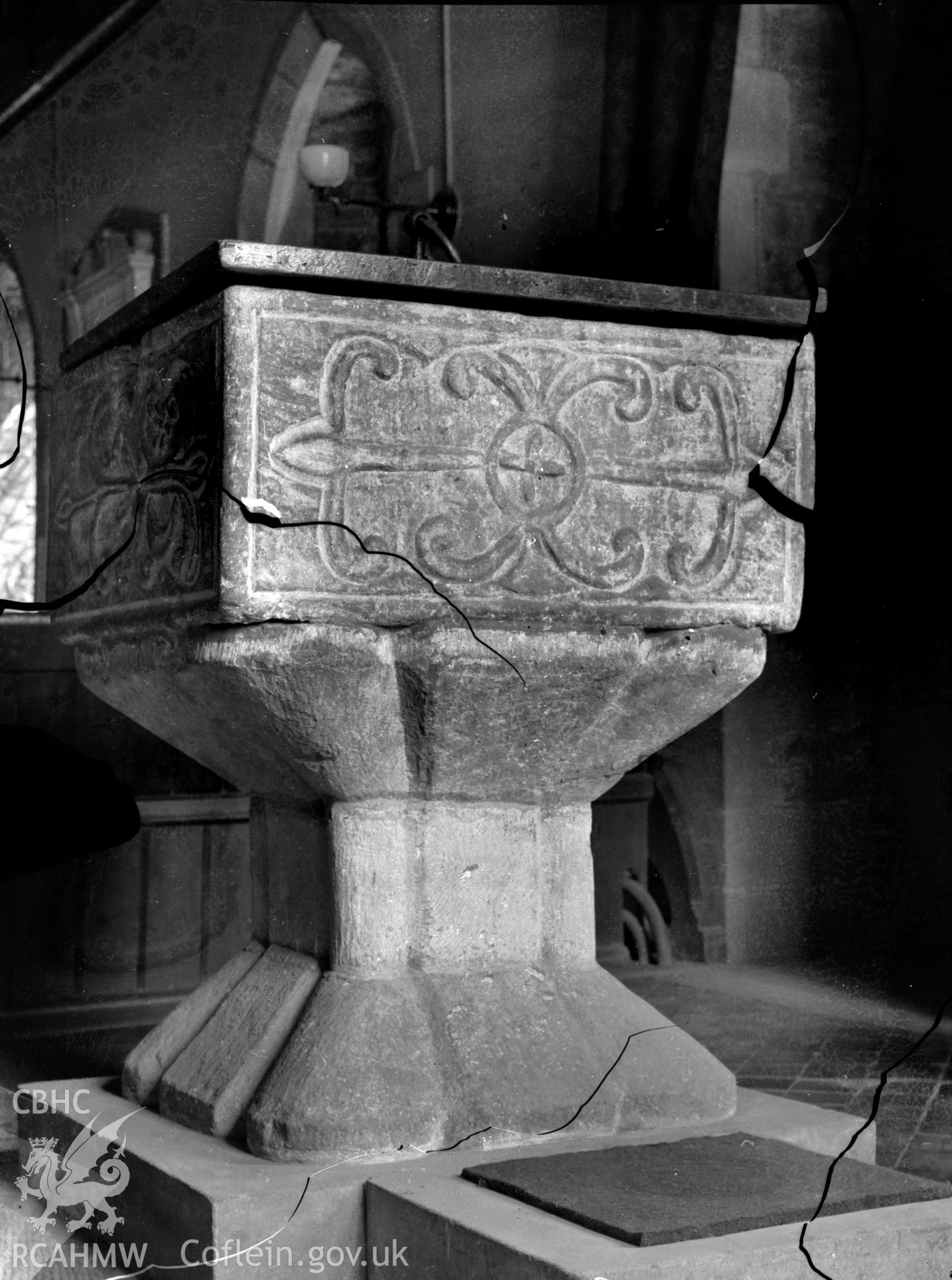 Black and white photo showing the font at St Issel's Church.