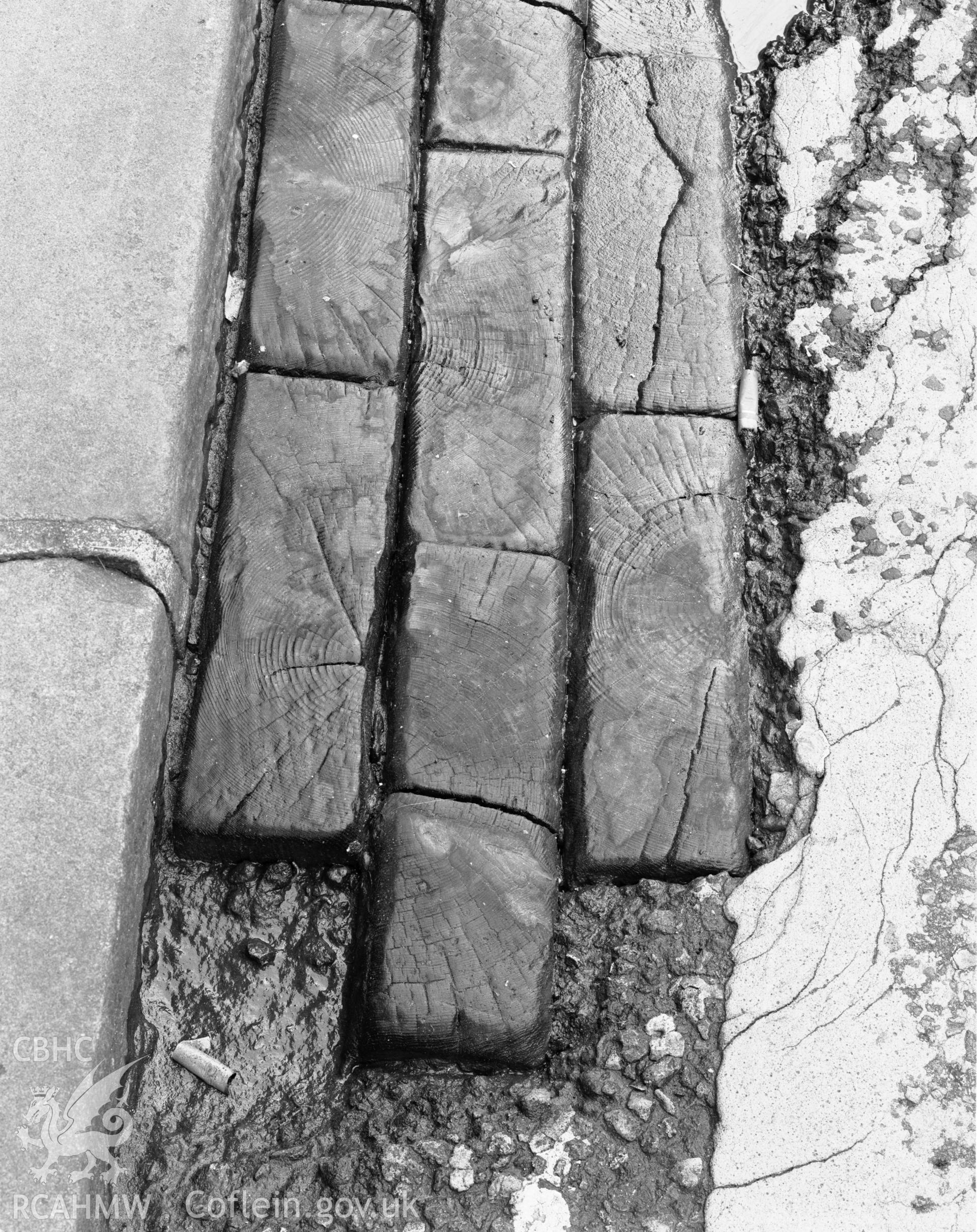 Old road surface on High Street, Pontypridd; photo survey comprising four black and white photographs produced by Iain Wright, 1999