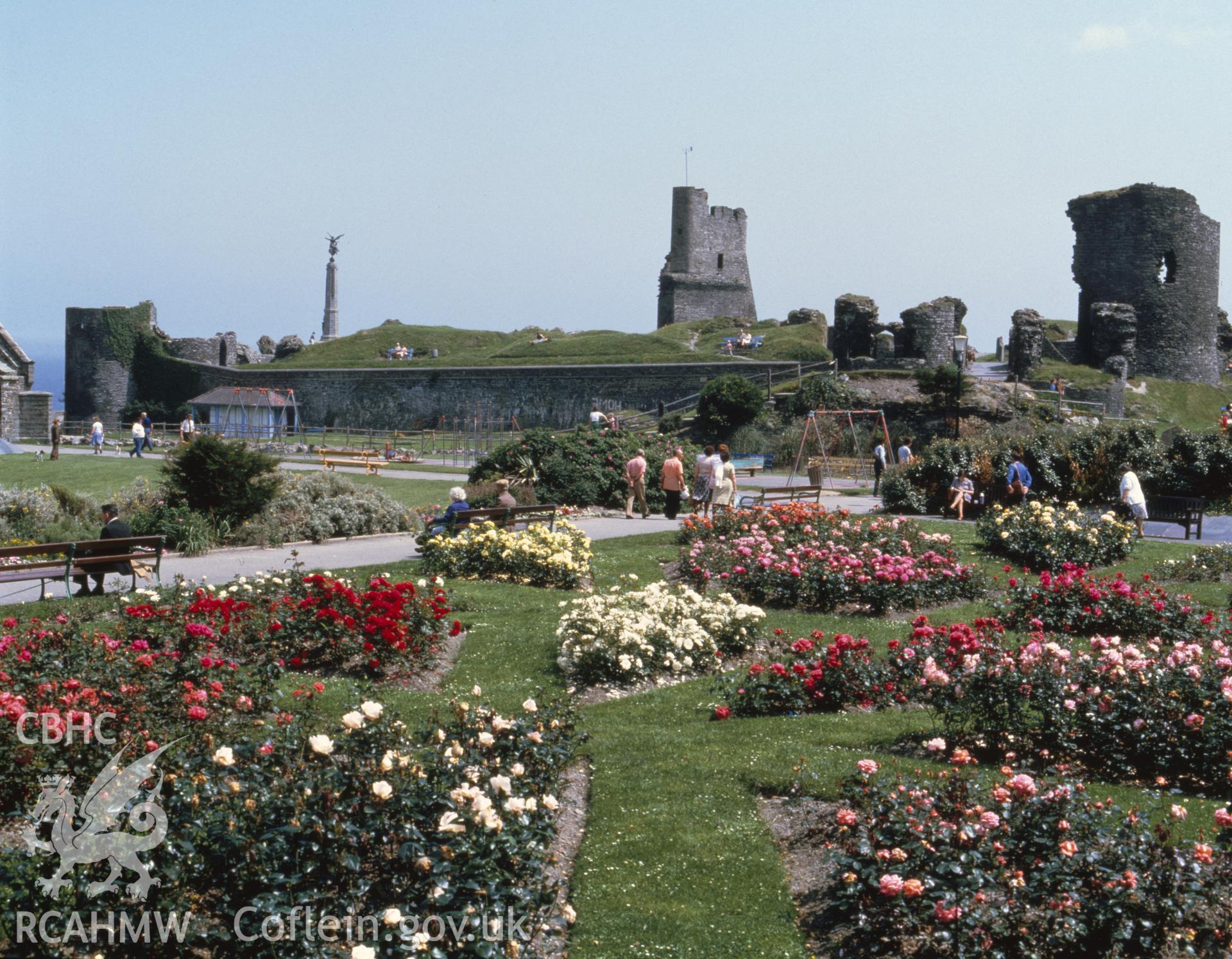 1 colour transparency showing view of Aberystwyth Castle grounds with rose garden and swings; collated by the former Central Office of Information.