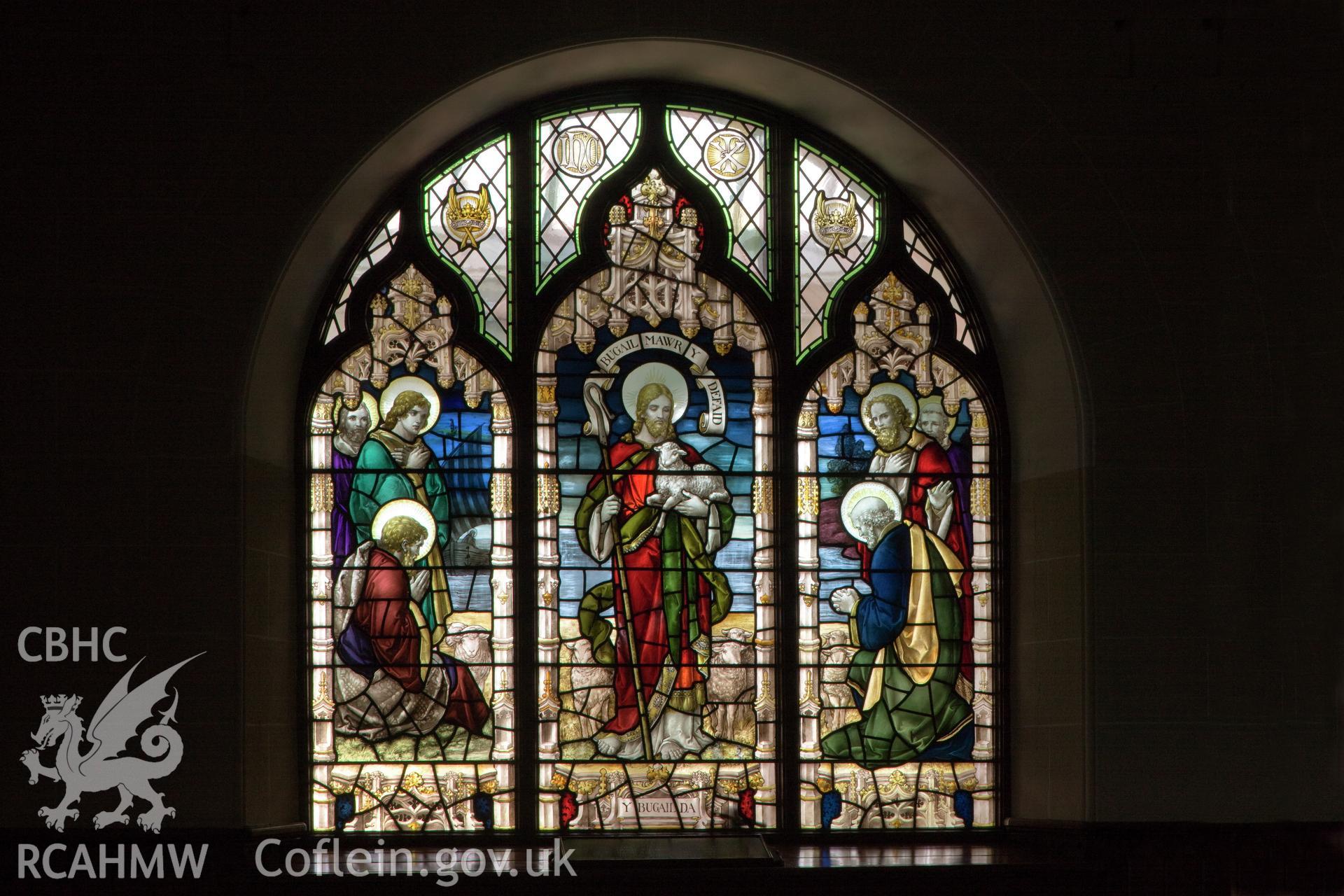 Memorial stained glass under balcony.