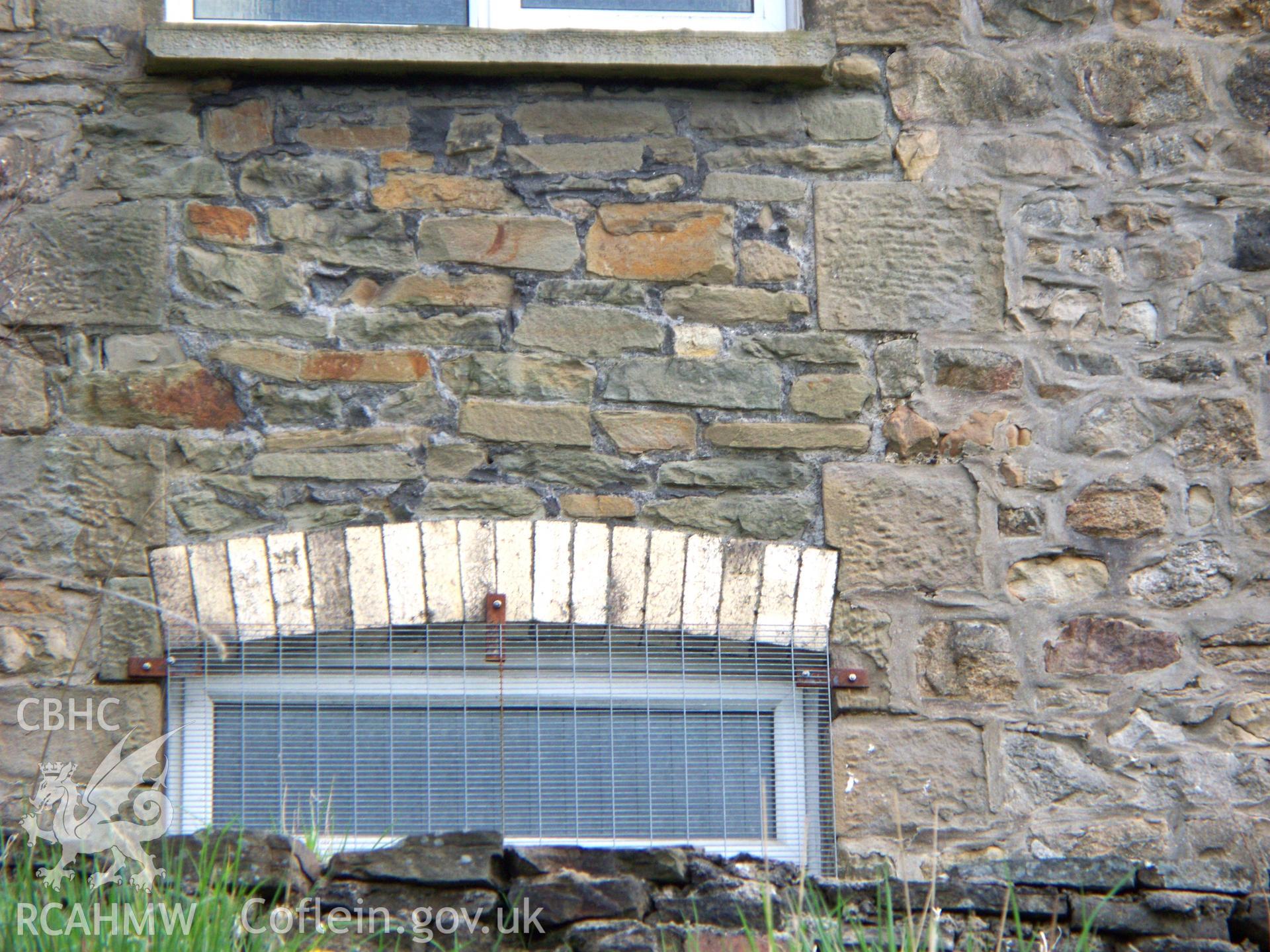 SE side showing original full-height window divided into two.