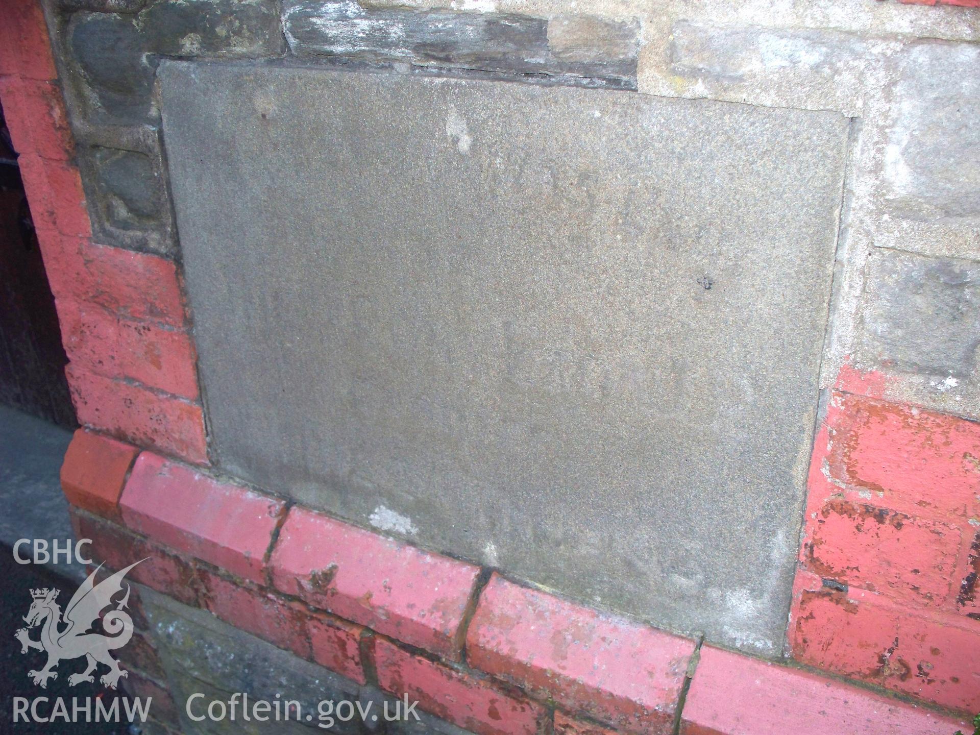 Eroded dated foundation stone on NW front.