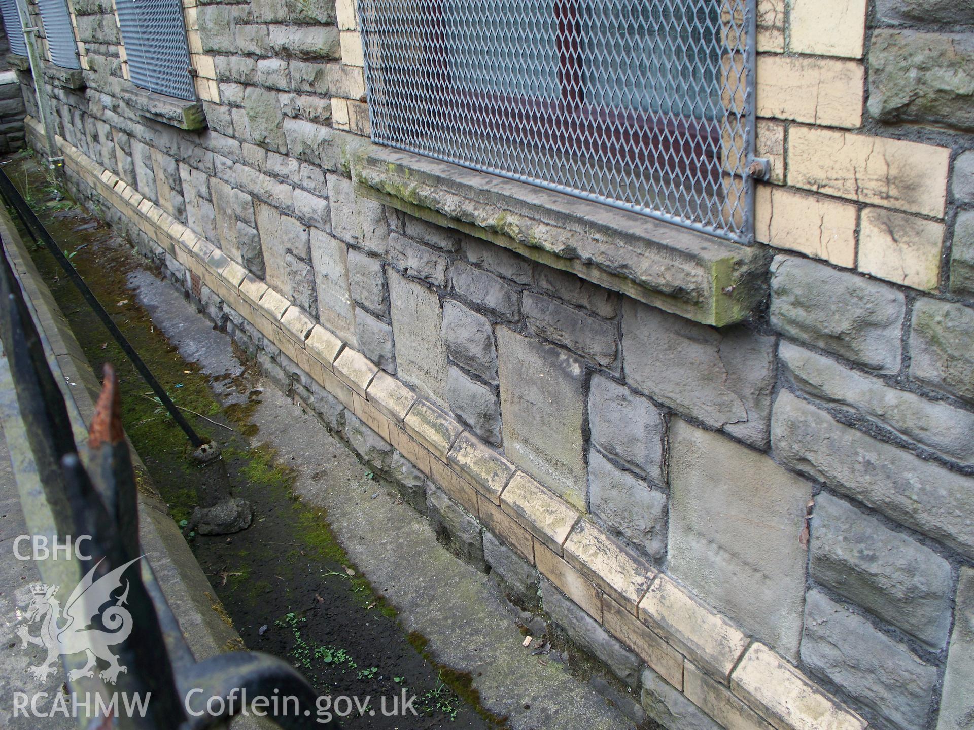Multiple eroded foundation stones on the NE fa?ade.