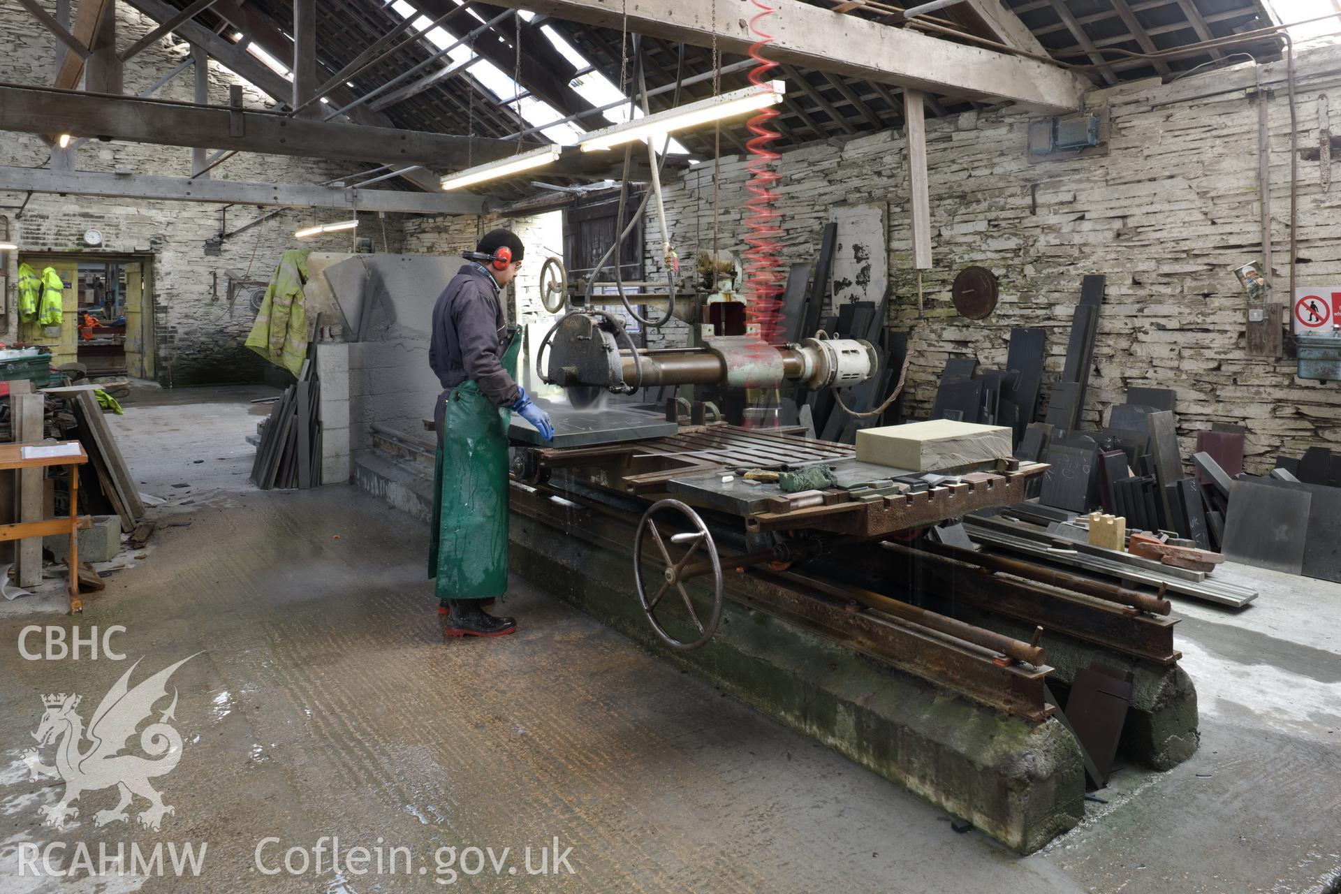 Cutting slate with slate saw.