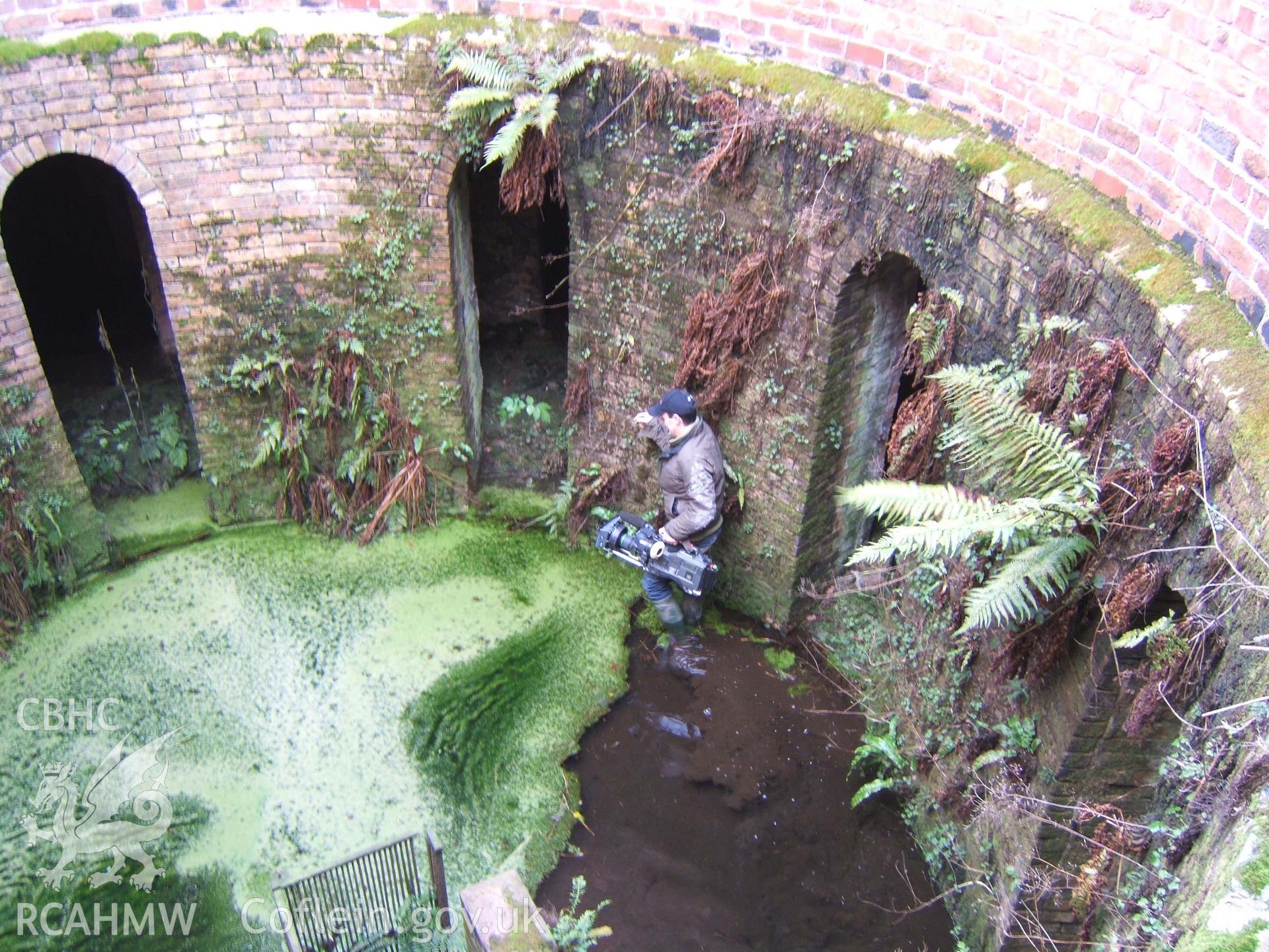 Cameraman walking around central slurry well.