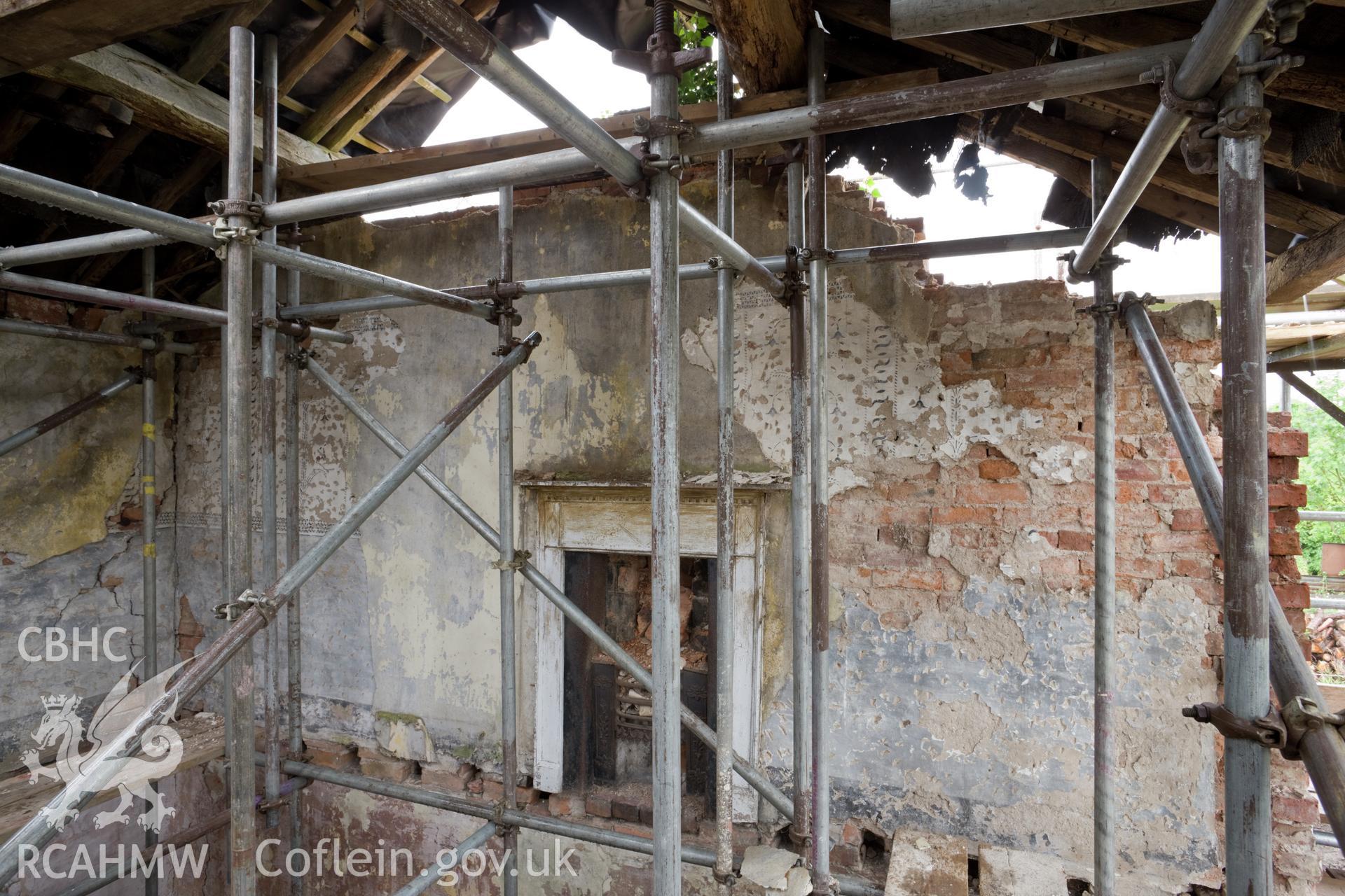 Interior north wall of central bay, first floor.