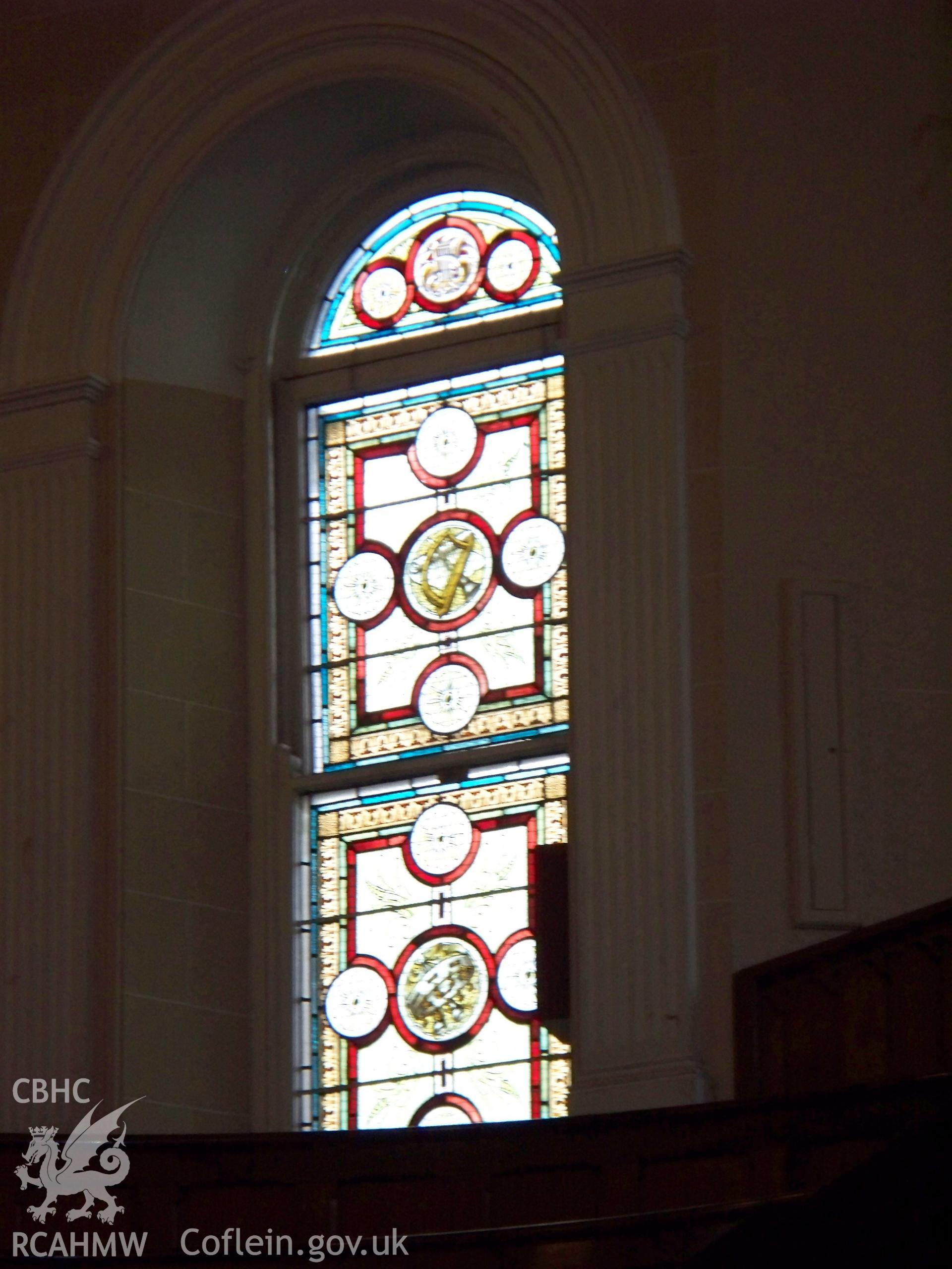 Detail of organ apse stained-glass with tambourine.