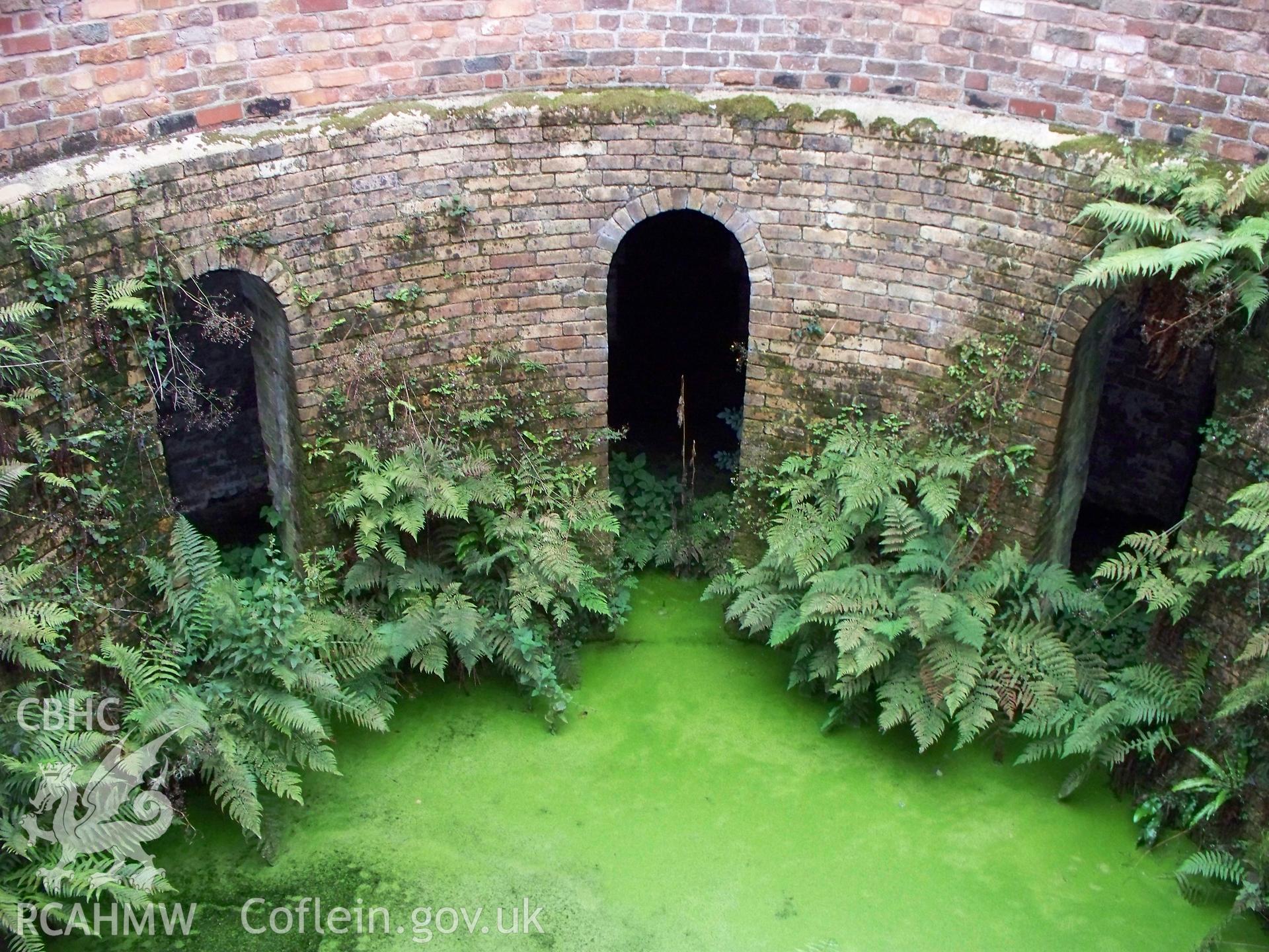 Looking east, from door, into the central slurry well showing basement arches.