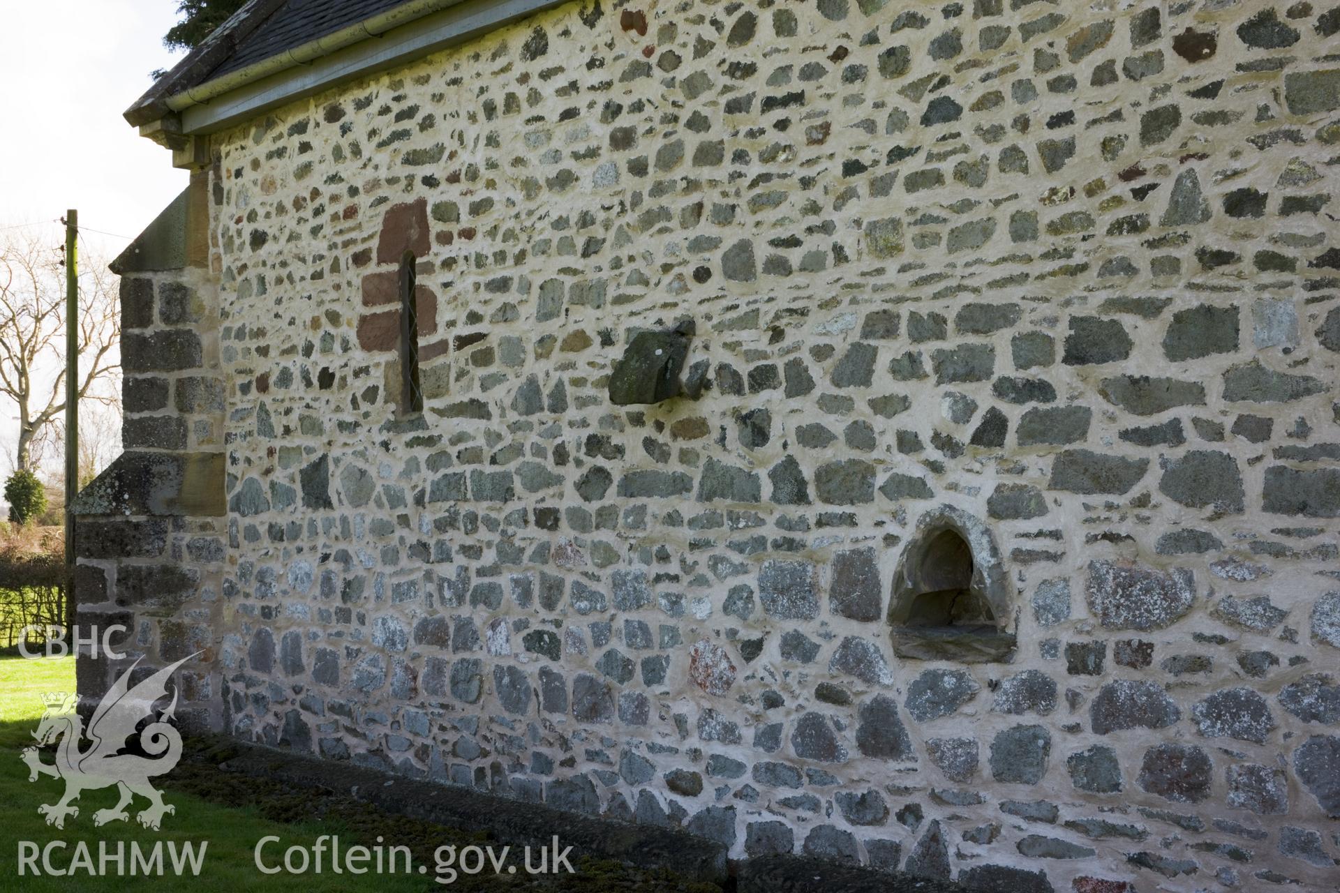Piscina and projecting stone in reworked north wall.