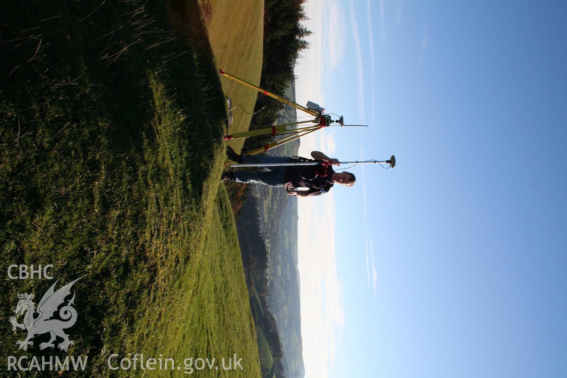 Pen'r-allt hillfort. Toby Driver surveying with GPS.