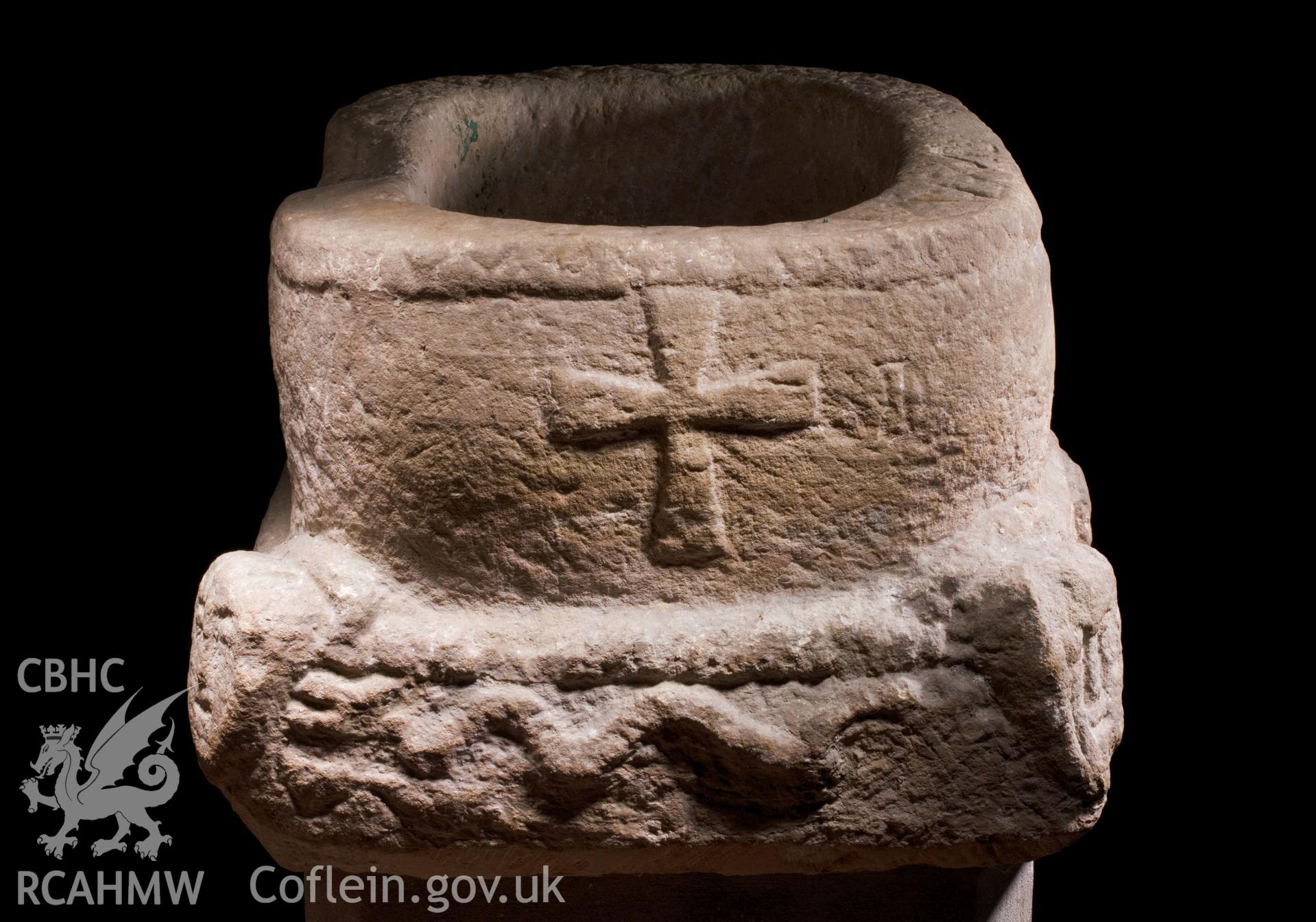 C12th font, cross and serpent, elevated viewpoint.