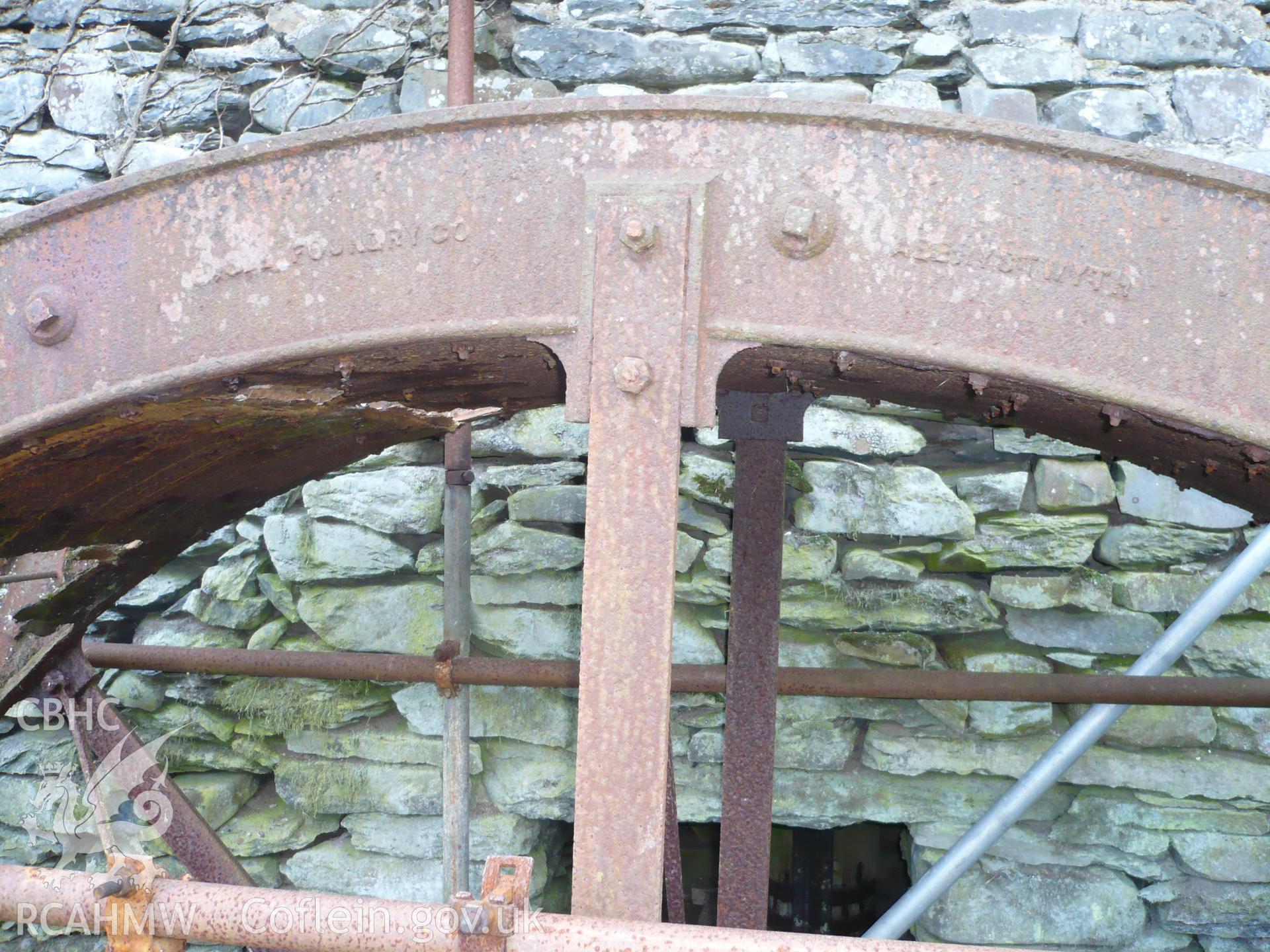 Detail of waterwheel showing maker's name.