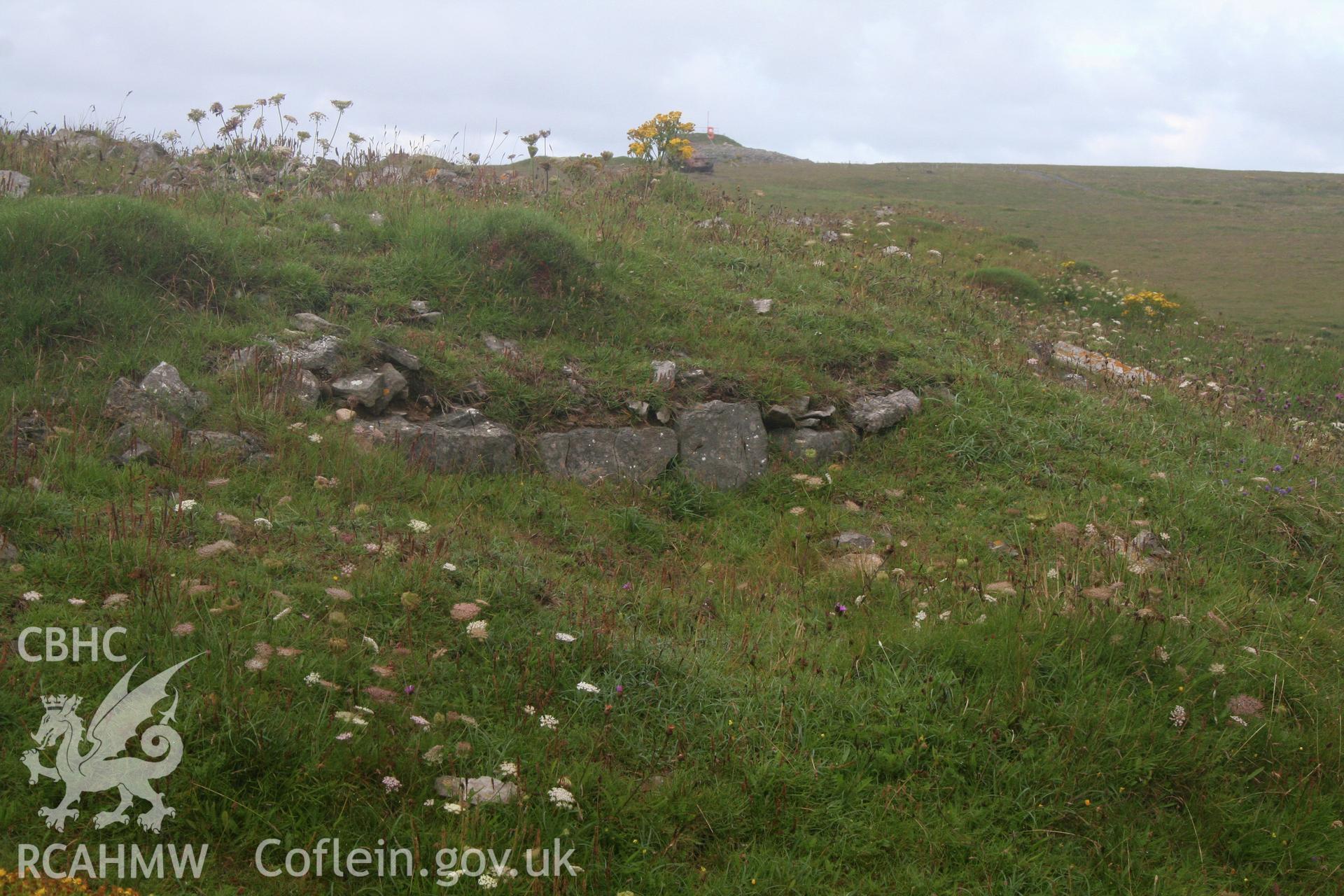 Section of wall, set on top of ditch defining the entrance 'forecourt' area.  Taken from the north-east.