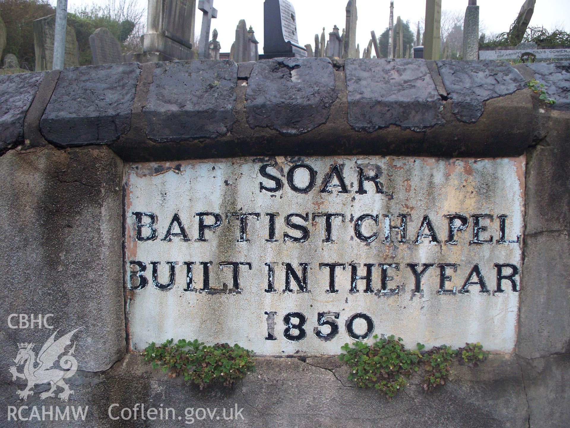 1850 plaque with cast copper-slag blocks on N retaining wall.