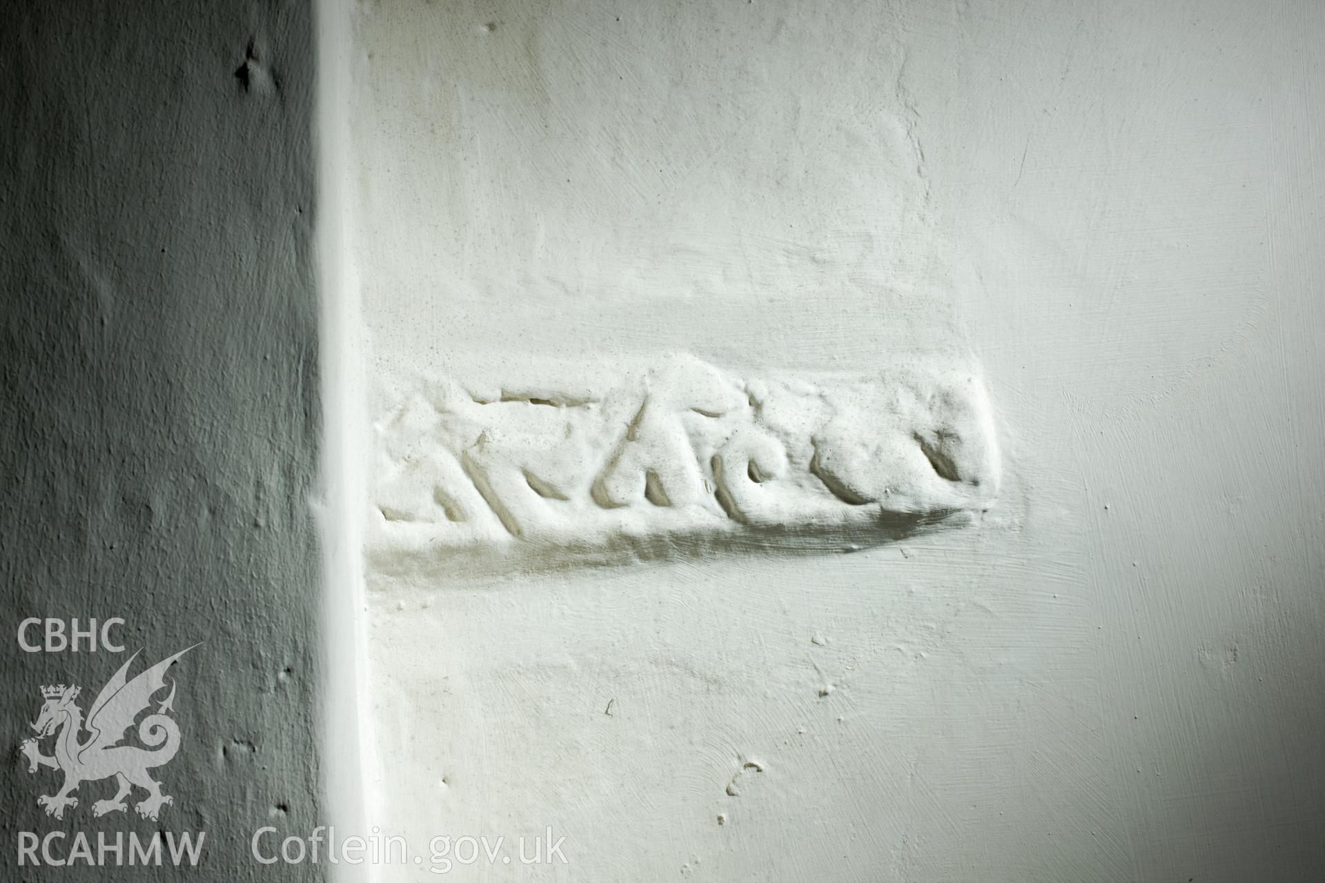 Early carved stone in interior north wall.