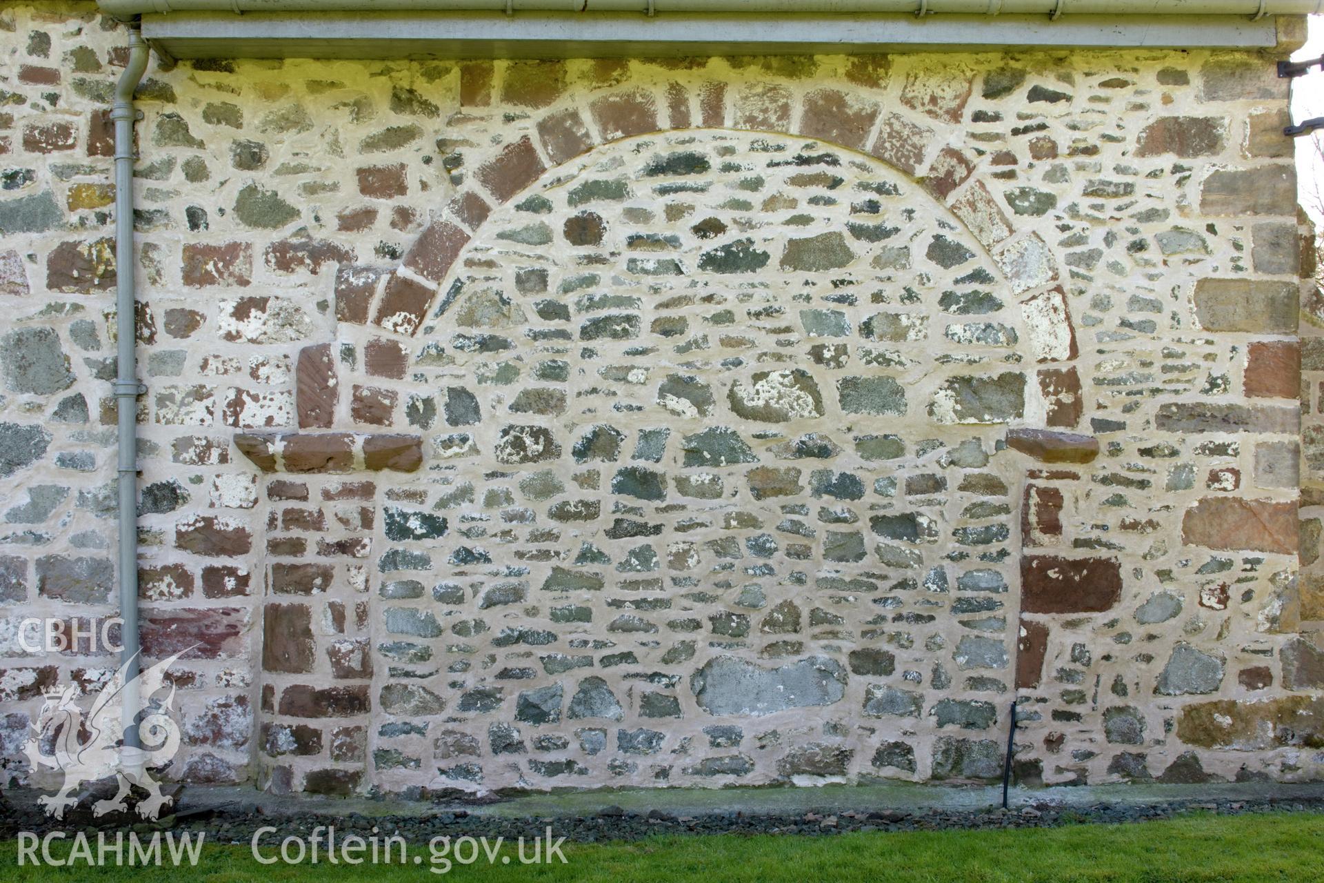 Blocked arch in north wall.