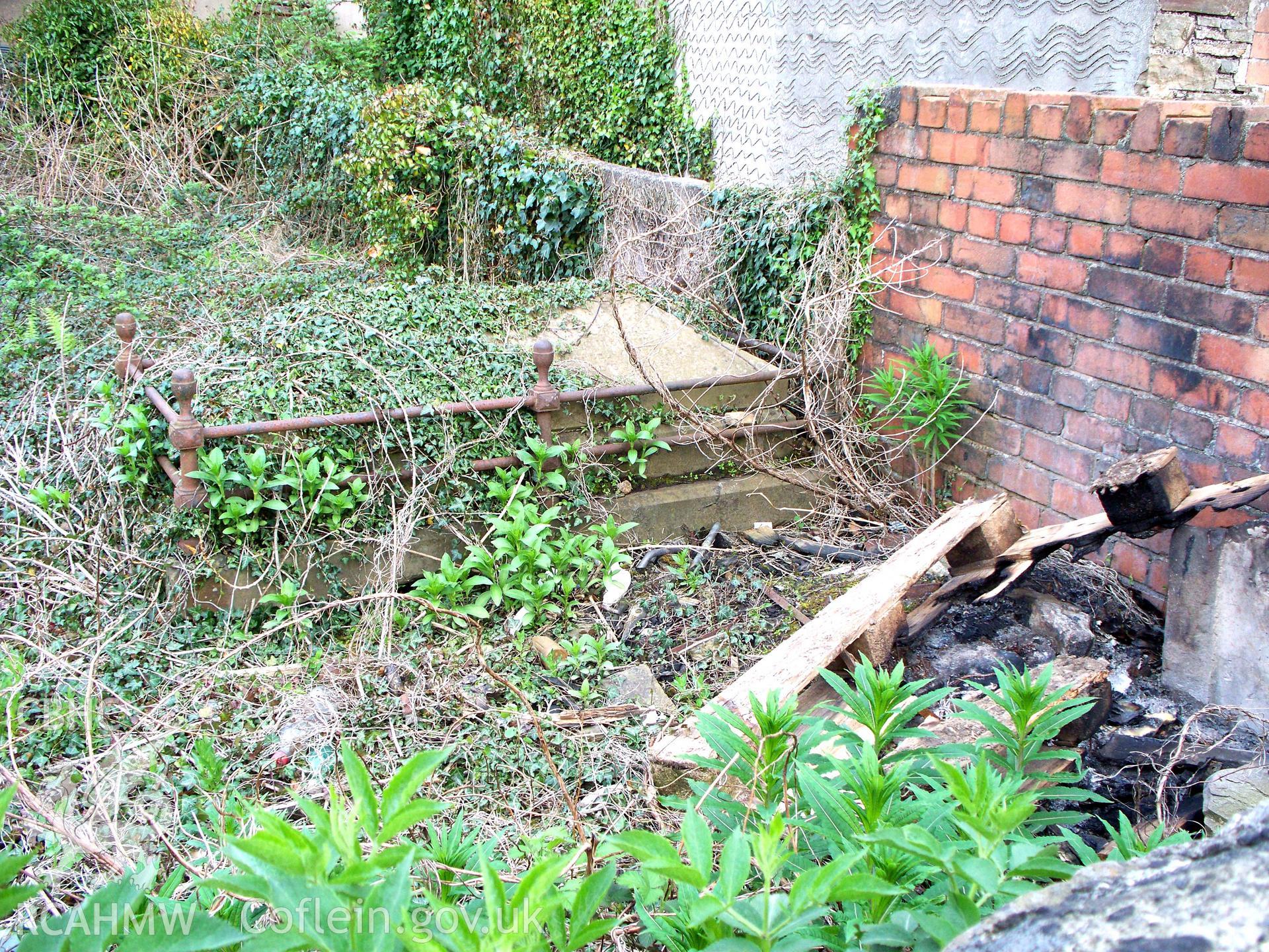 Tomb in derelict burial ground near north wall of chapel.