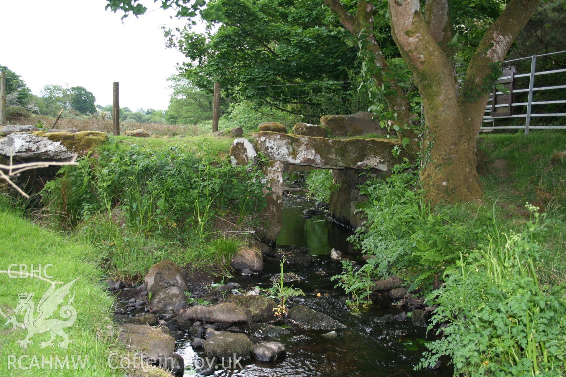 Stone slab bridge over stream.
